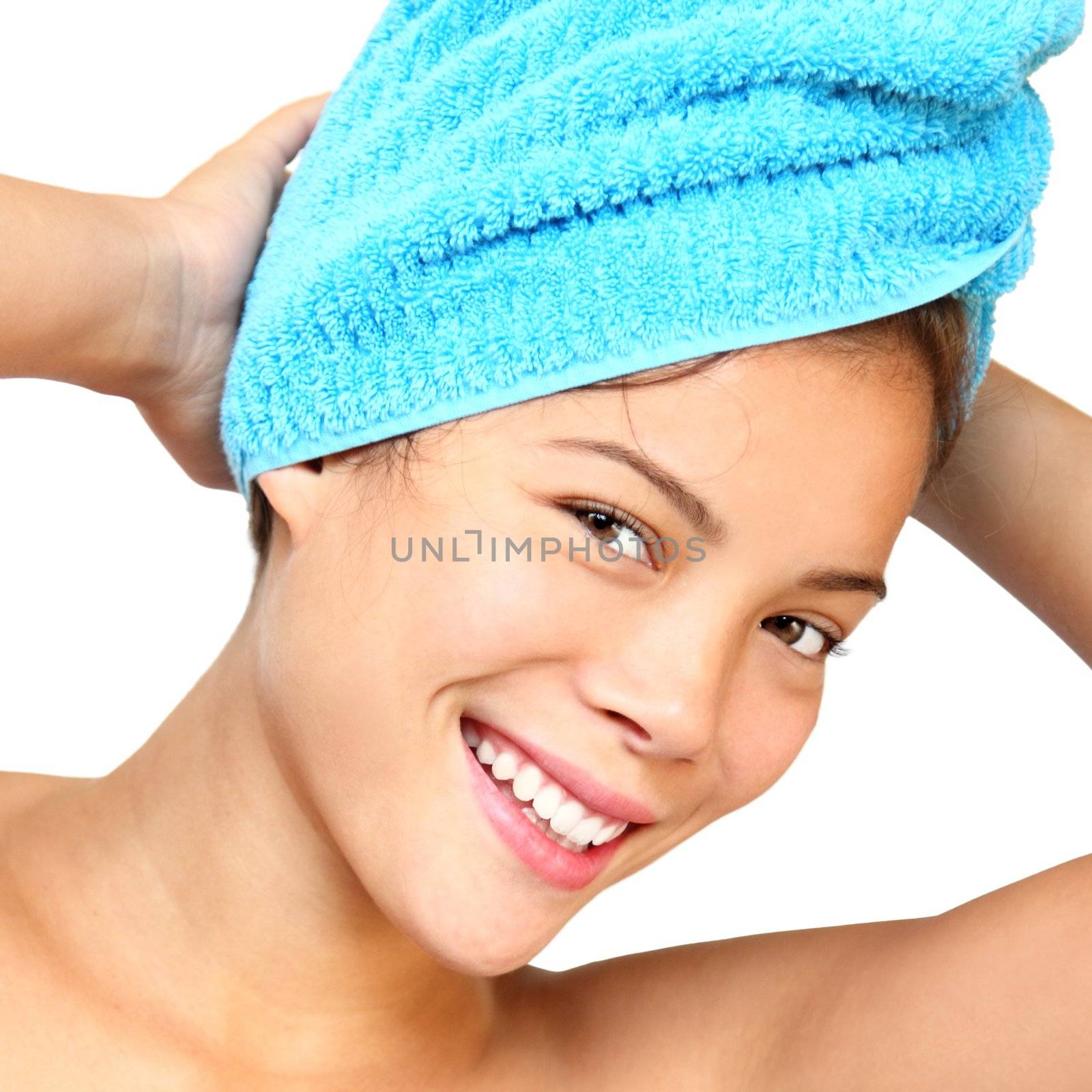 Towel woman. Smiling woman with towels just out of the shower. Beautiful mixed asian / caucasian young woman model. Isolated on white background.