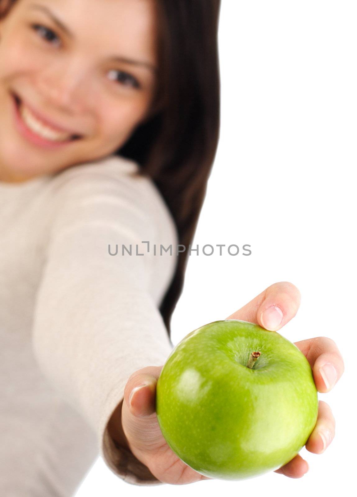 Eat healthy concept. Beautiful autumn woman giving you an apple. Isolated on white background. Shallow depth of field, focus on the apple