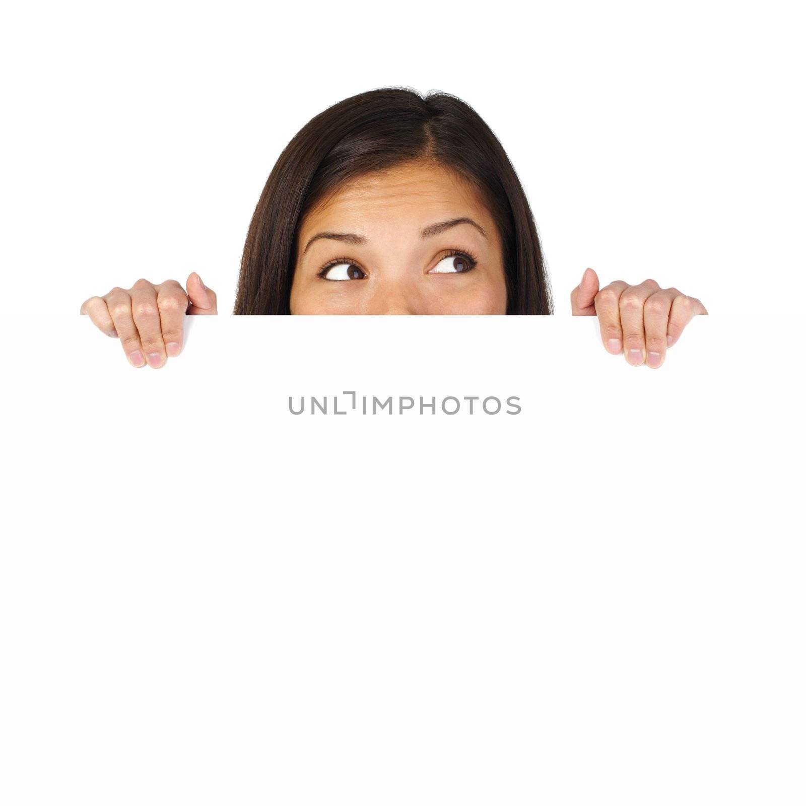 Woman holding and hiding behind billboard / blank sign looking up. Isolated on white.