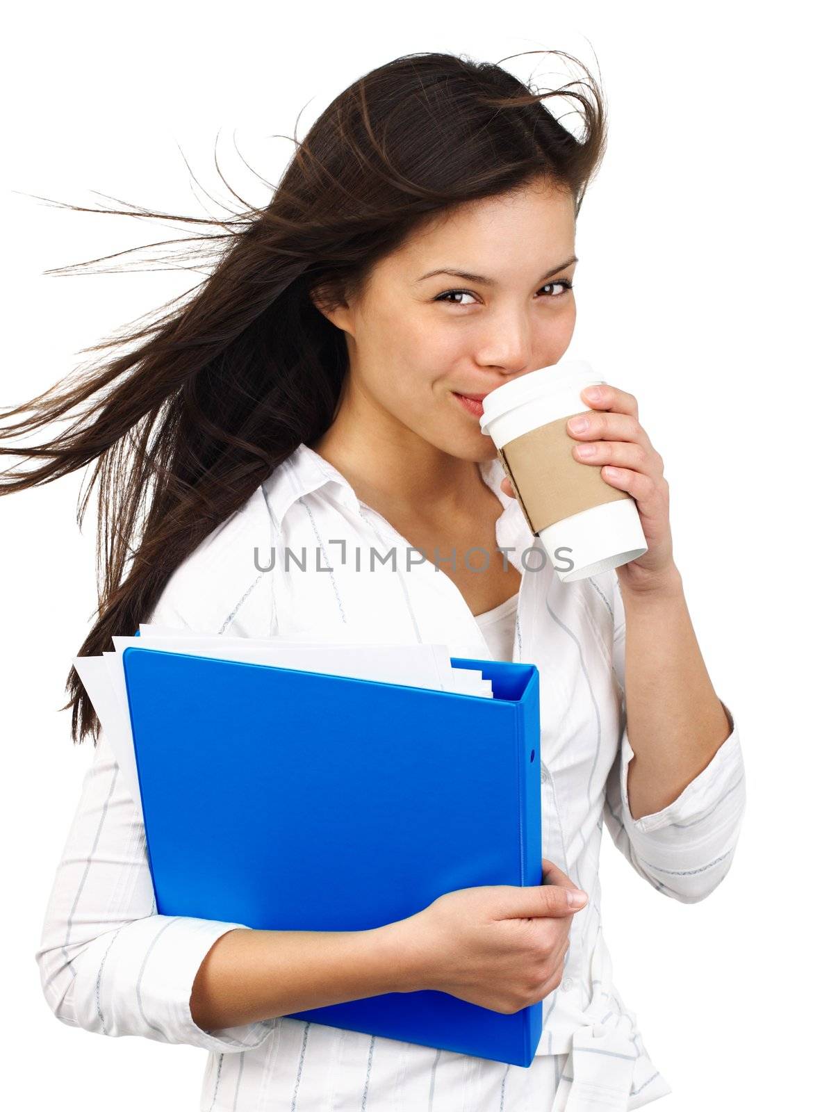 Confident smiling young businesswoman on the move drinking coffee from disposable cup. Isolated on white background.