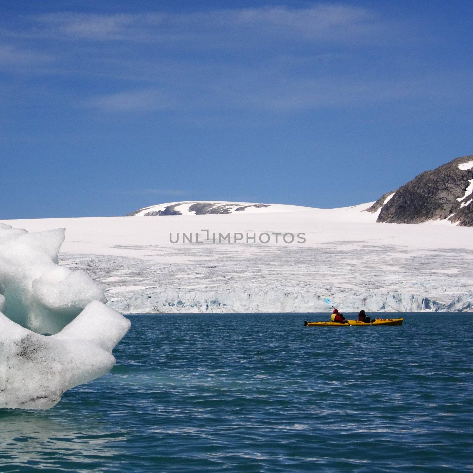 Kayak near glacier front and icebergs in Jostedal, Norway