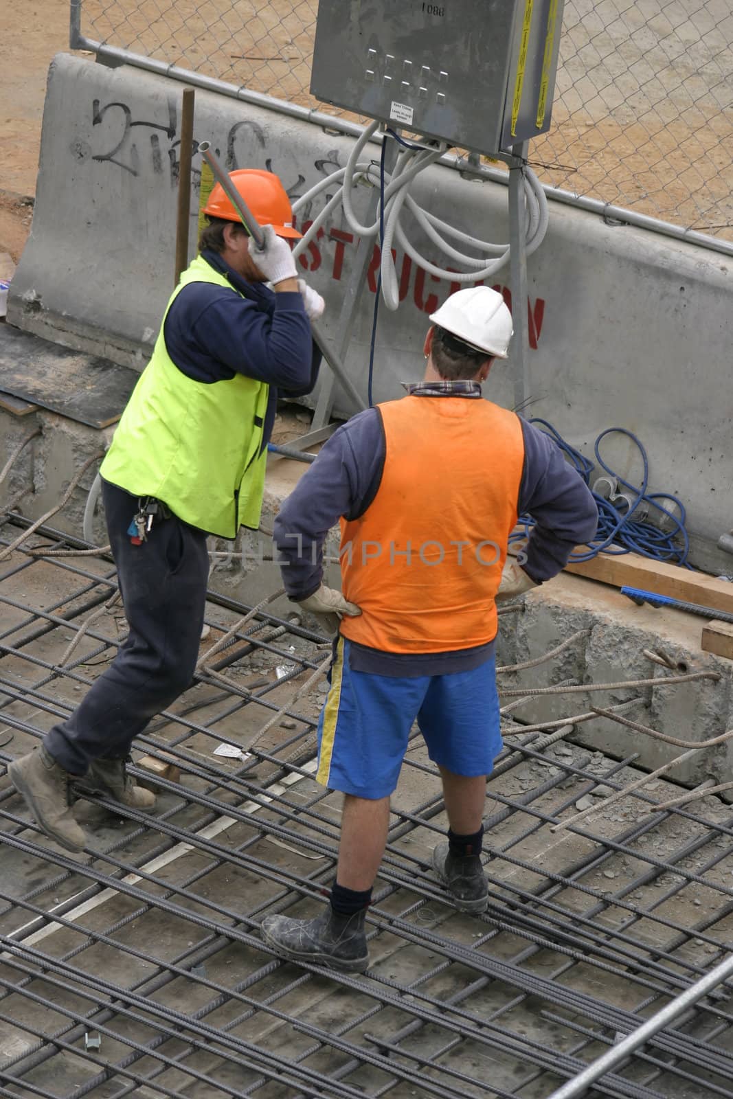 Two construction men at a worksite
