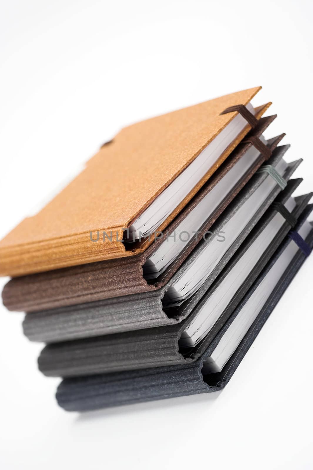 Stack of notebooks  with color cover over white