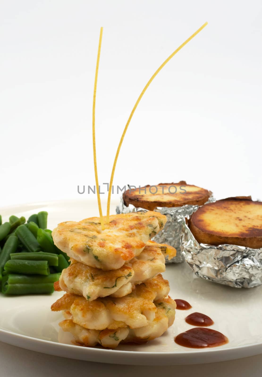 chicken cutlets, served on a plate with baked potatoes