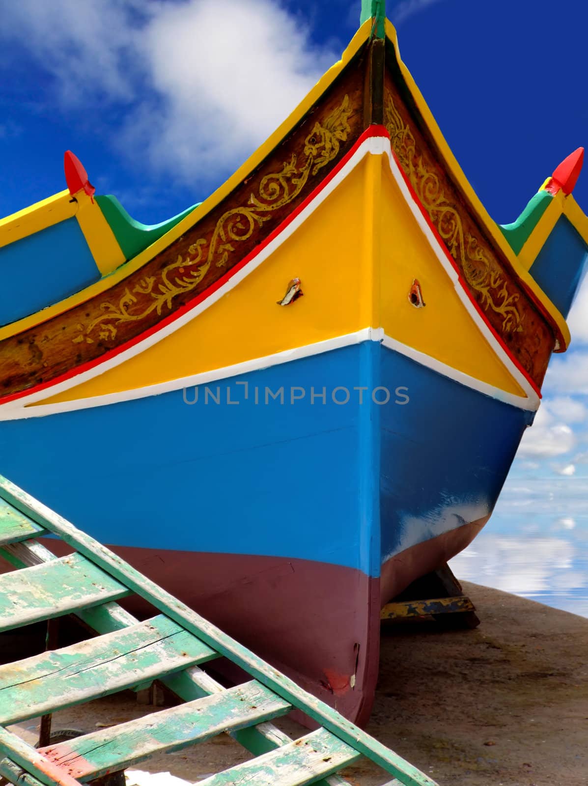 Traditional colors of the traditional Malta fishing boats, commonly known as luzzu or dghajsa. This one is attending repair on a quayside