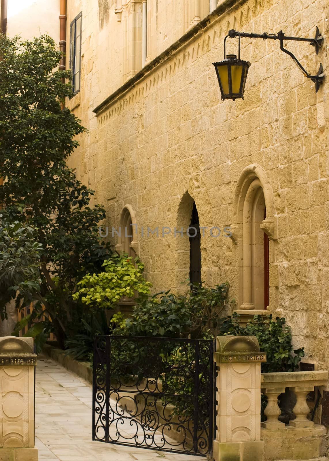 A medieval limestone facade in traditional baroque style in Mdina on the island of Malta