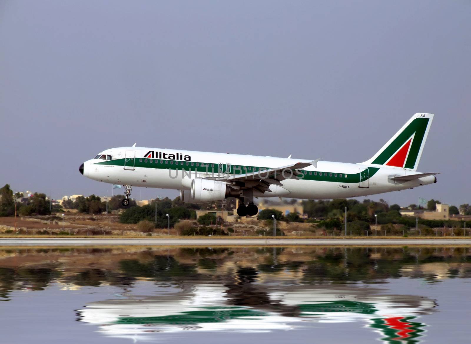 Italian Alitalia jet landing on an airport runway