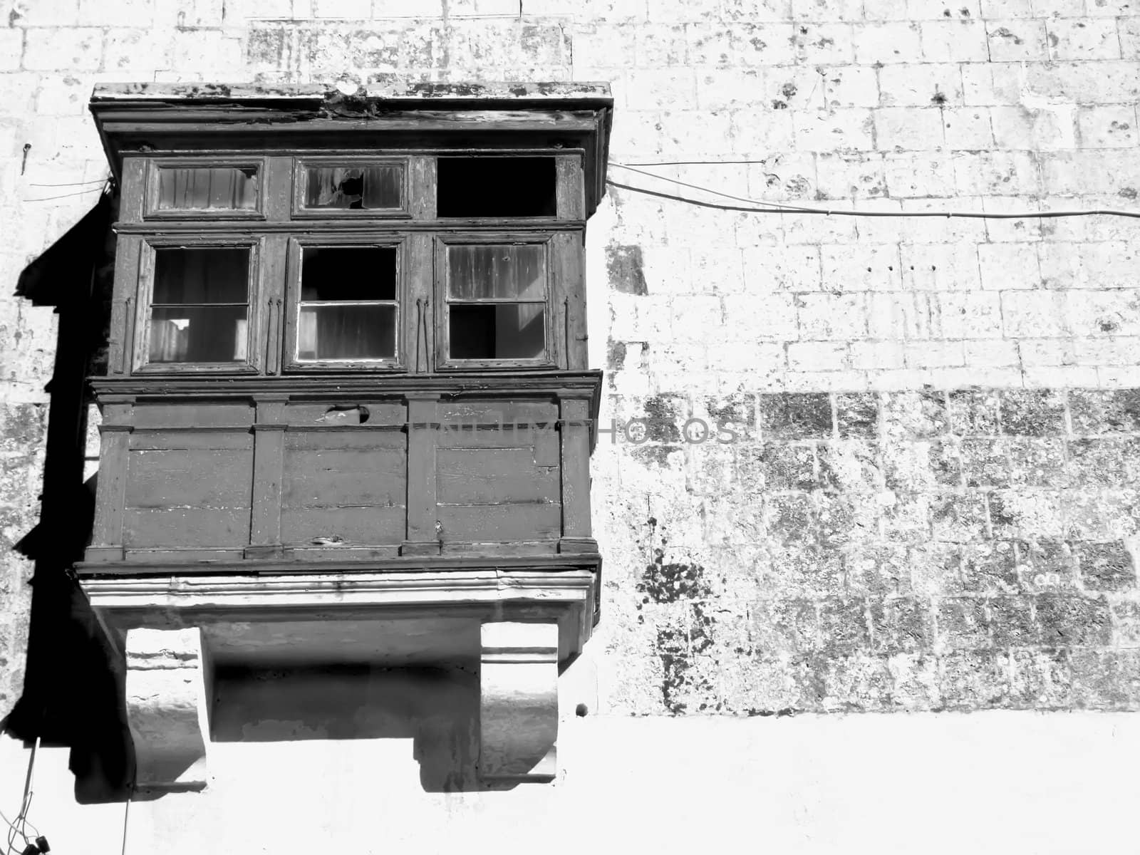 Medieval battered and derelict balcony of house in the old city of Mdina, Malta