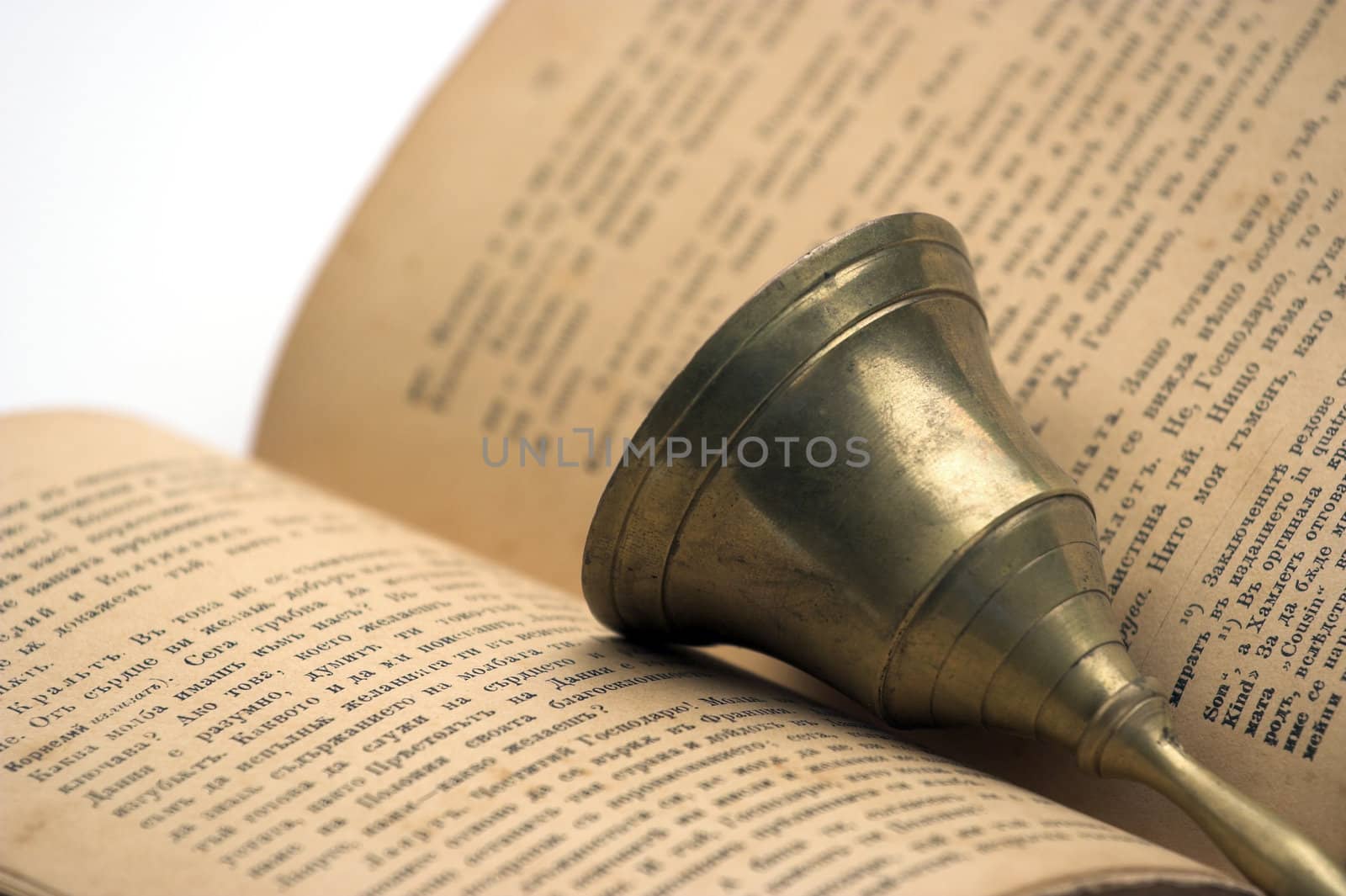 Old book and handbell close up