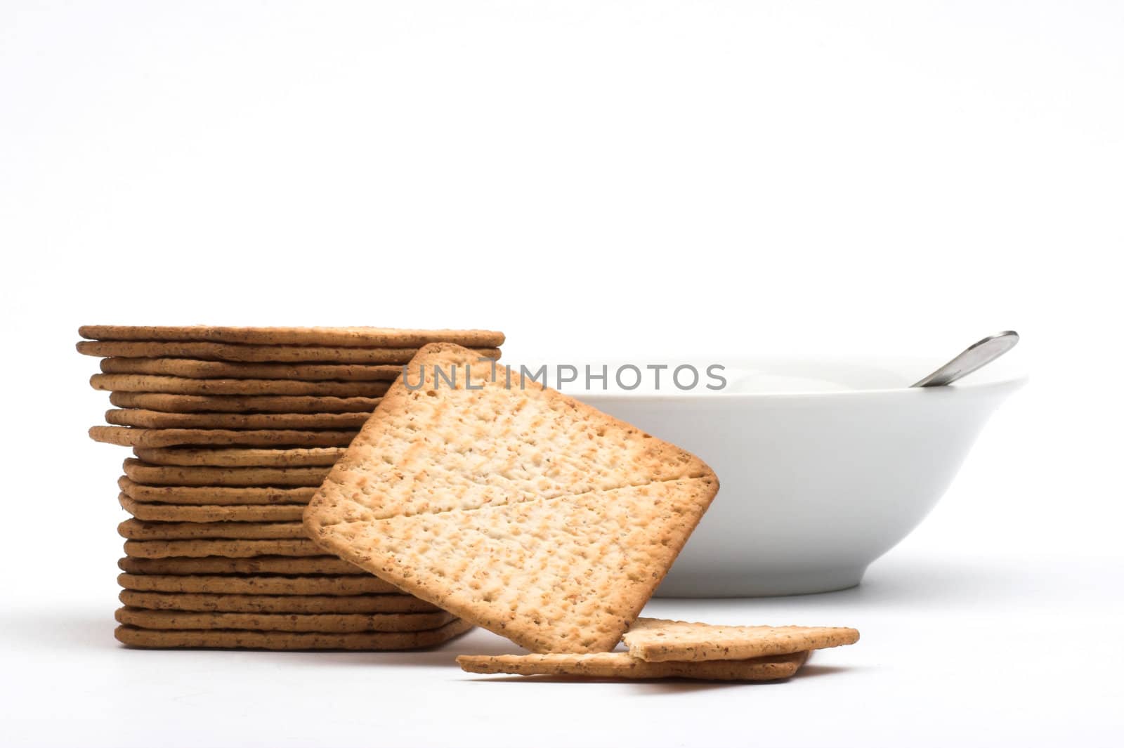 A stack of crackers   and white cup 