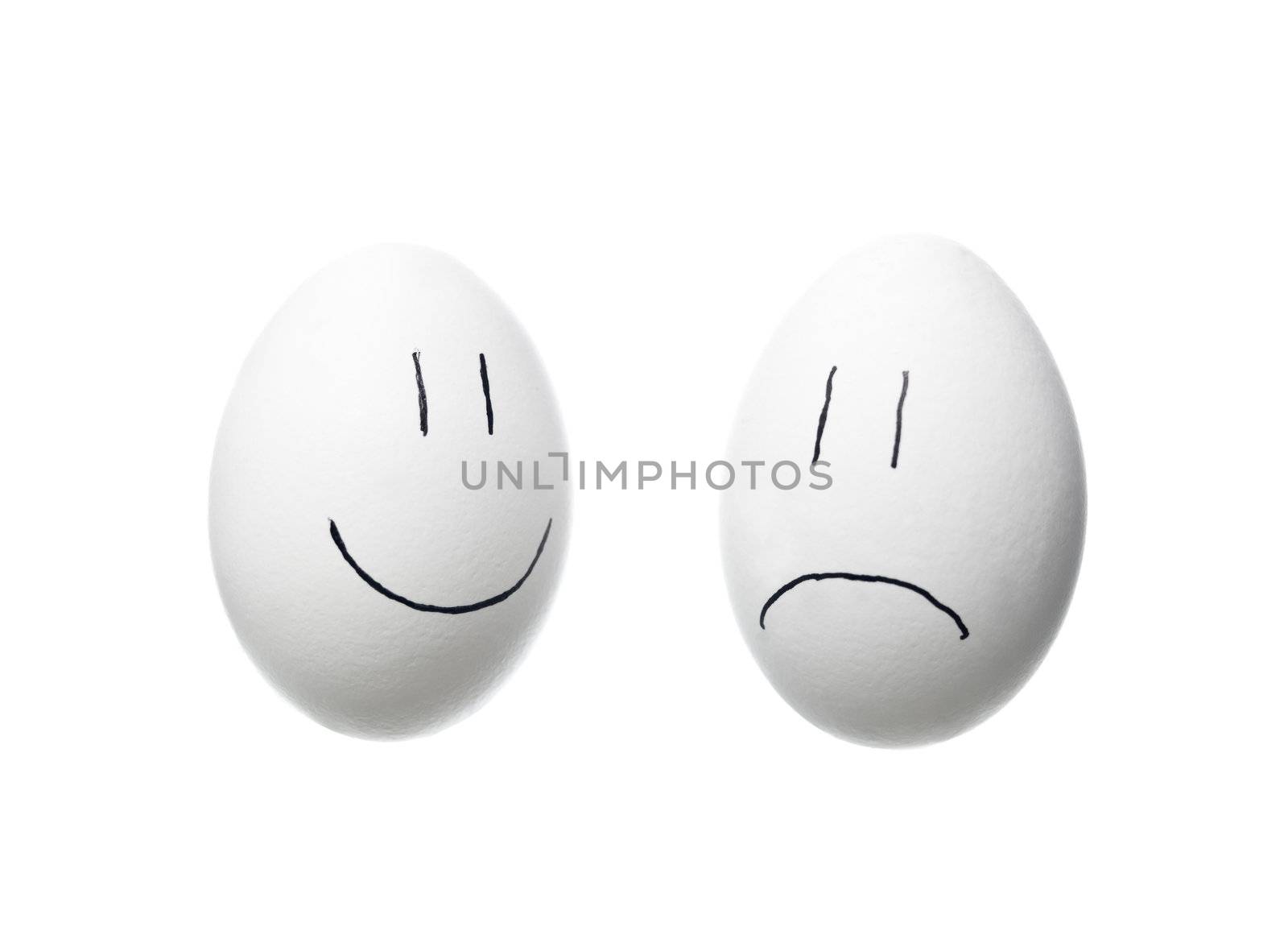 Sad face and a happy face painted on white eggs isolated on white