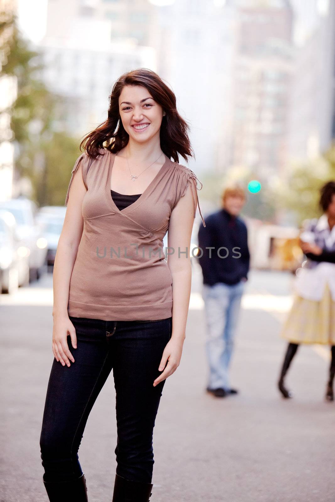 A woman in a city setting with friends in the background