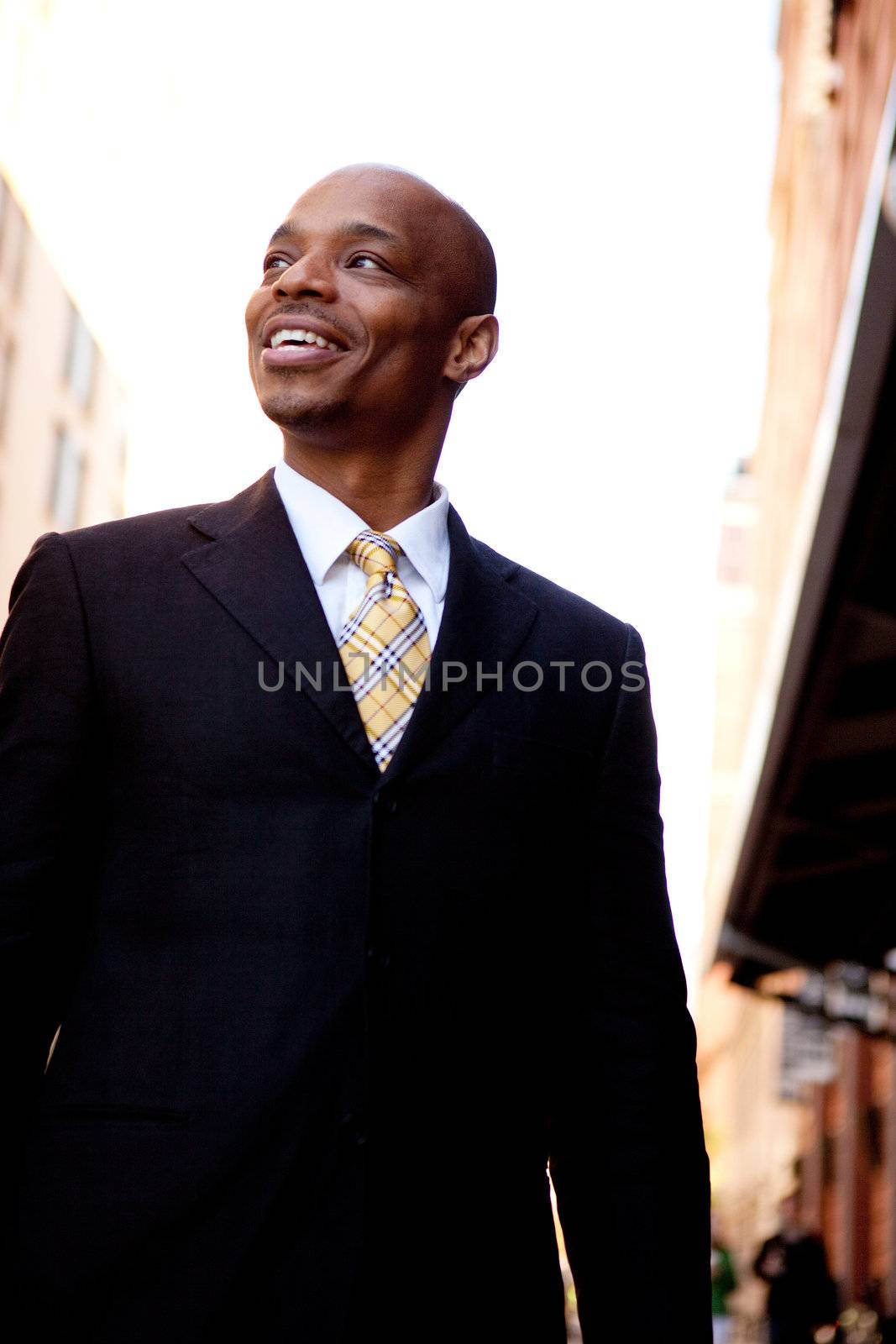 A street portrait of a business man walking on a sidewalk