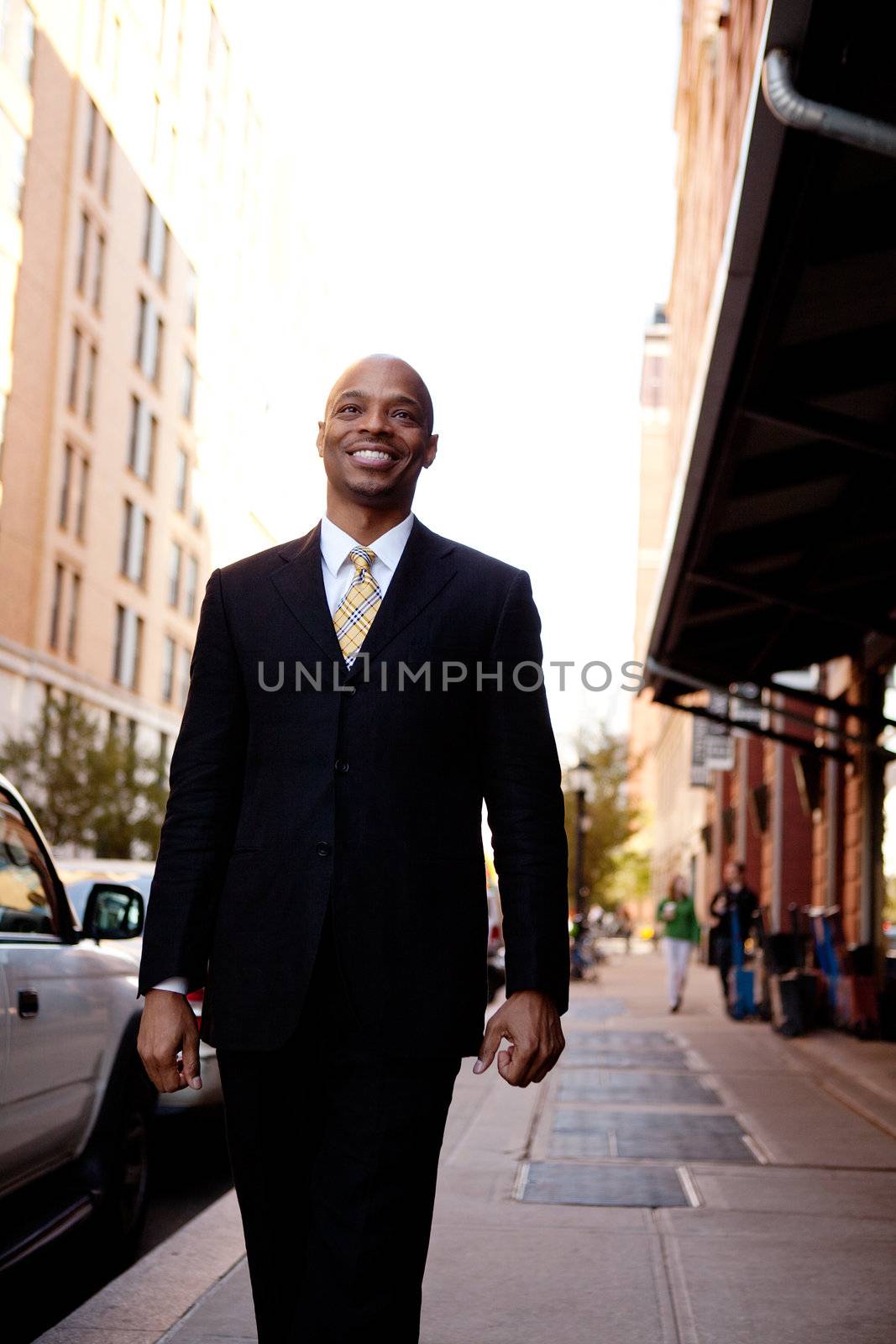 A street portait of a busienss man walking down the sidewalk