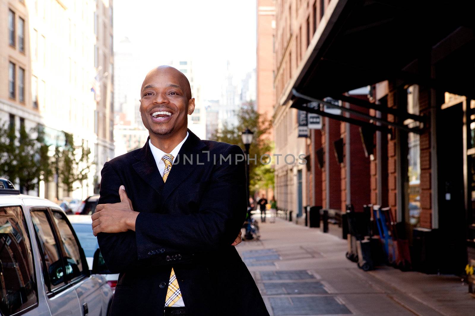 A happy business man, downtown in a city