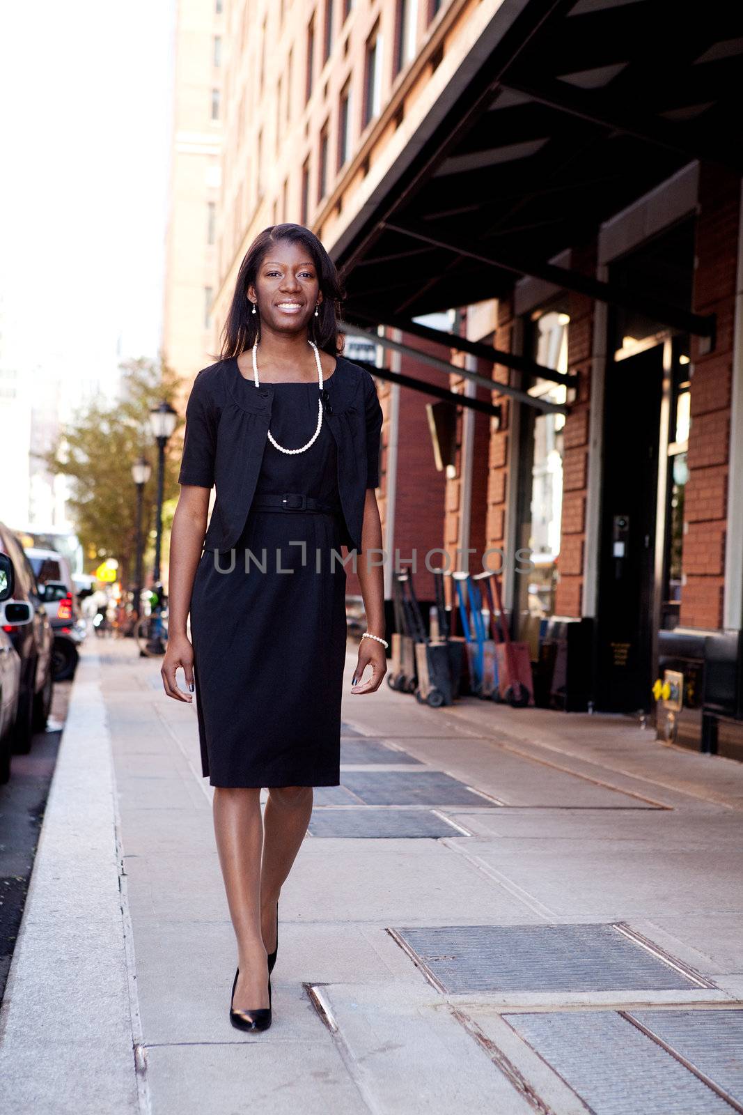 An African American business woman in an urban setting.