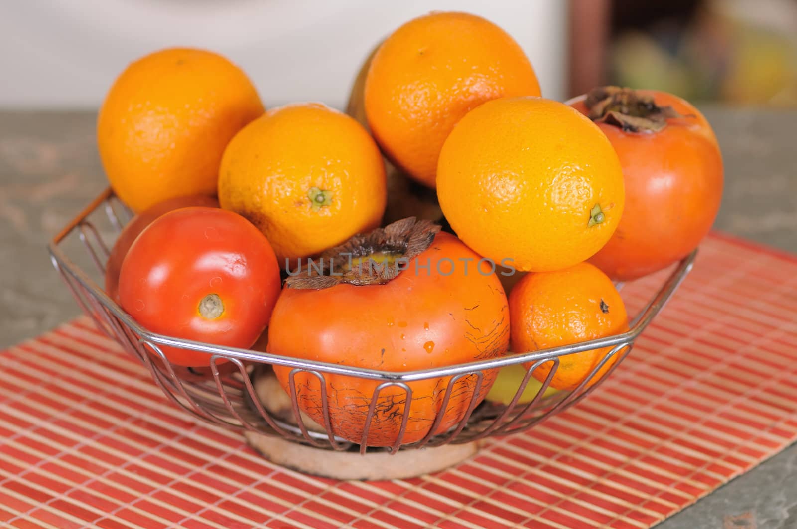 Fresh ripe fruit in a metal vase on a table