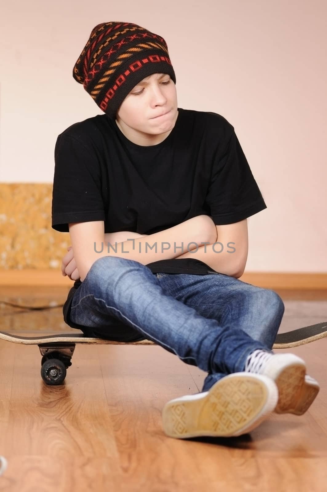 The teenager with a skateboard and in a hat