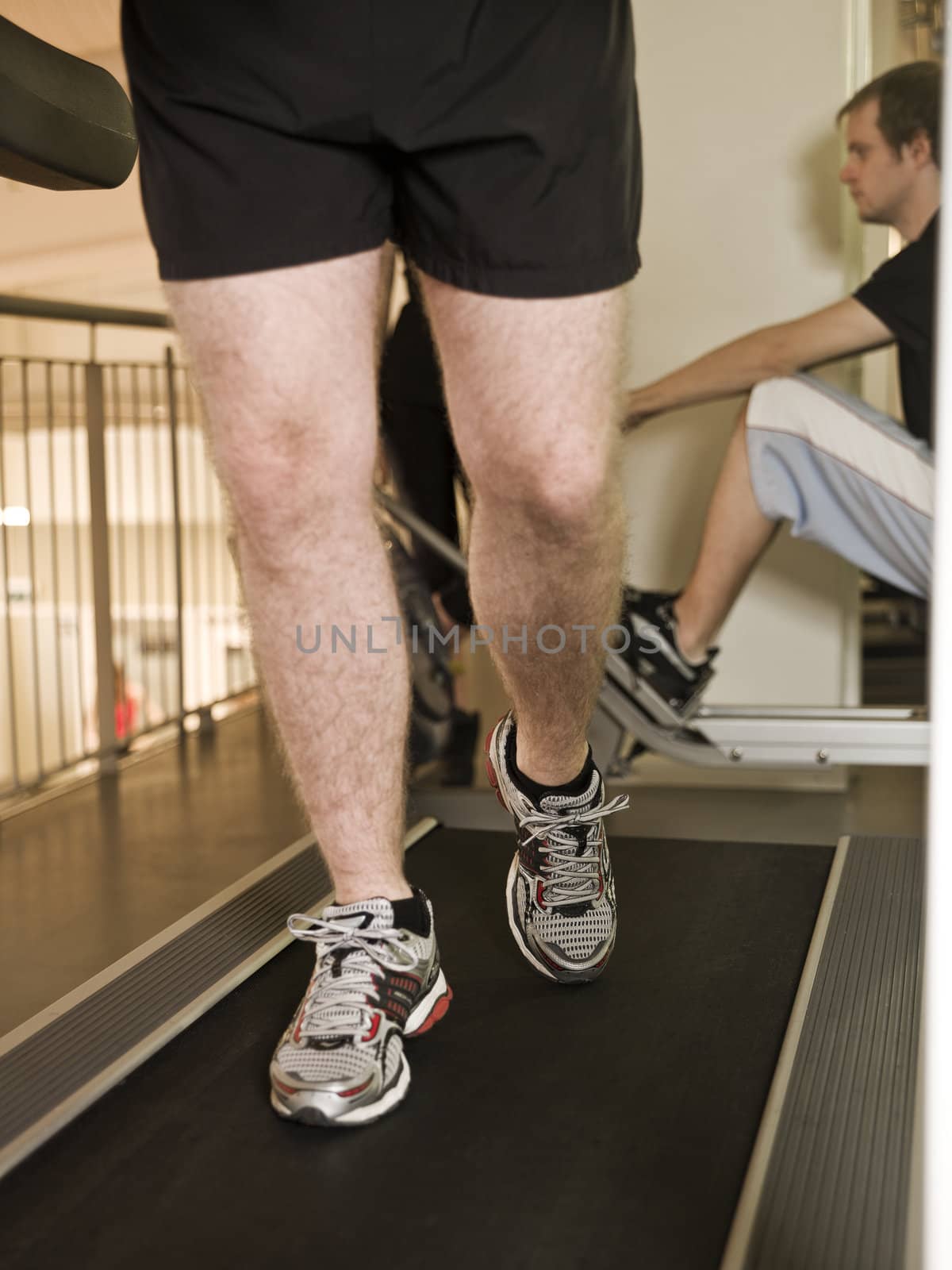 Man running on a treadmill by gemenacom