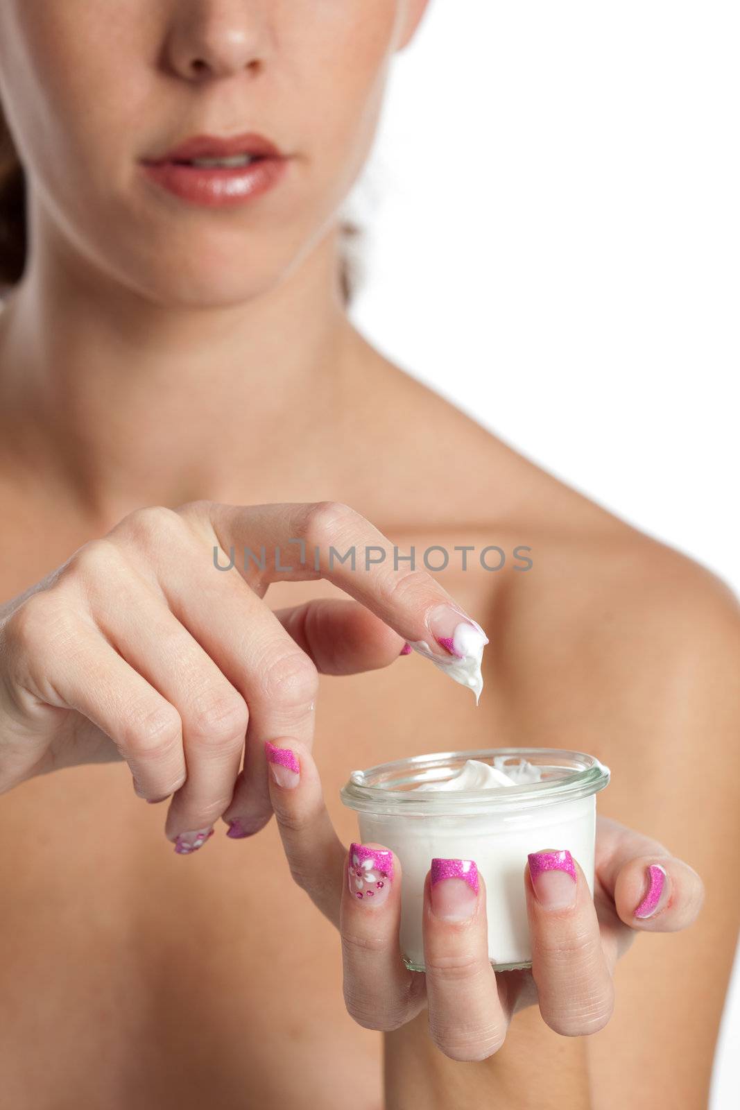 Woman hand dipping her finger in a jar of cream