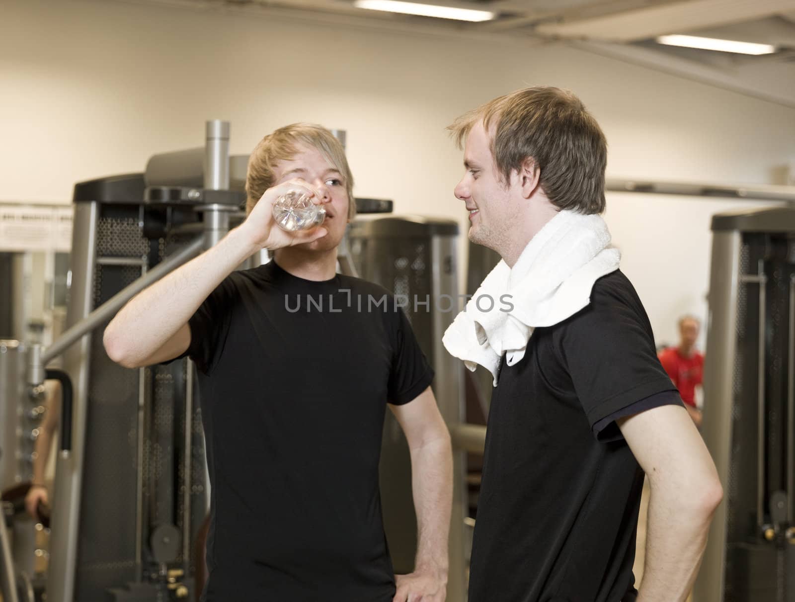 Two young men talking at a healthc club