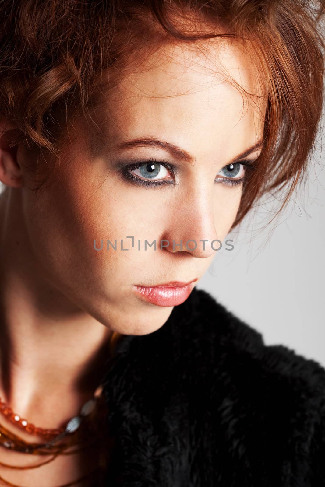 Beautiful woman with red hair and intense look