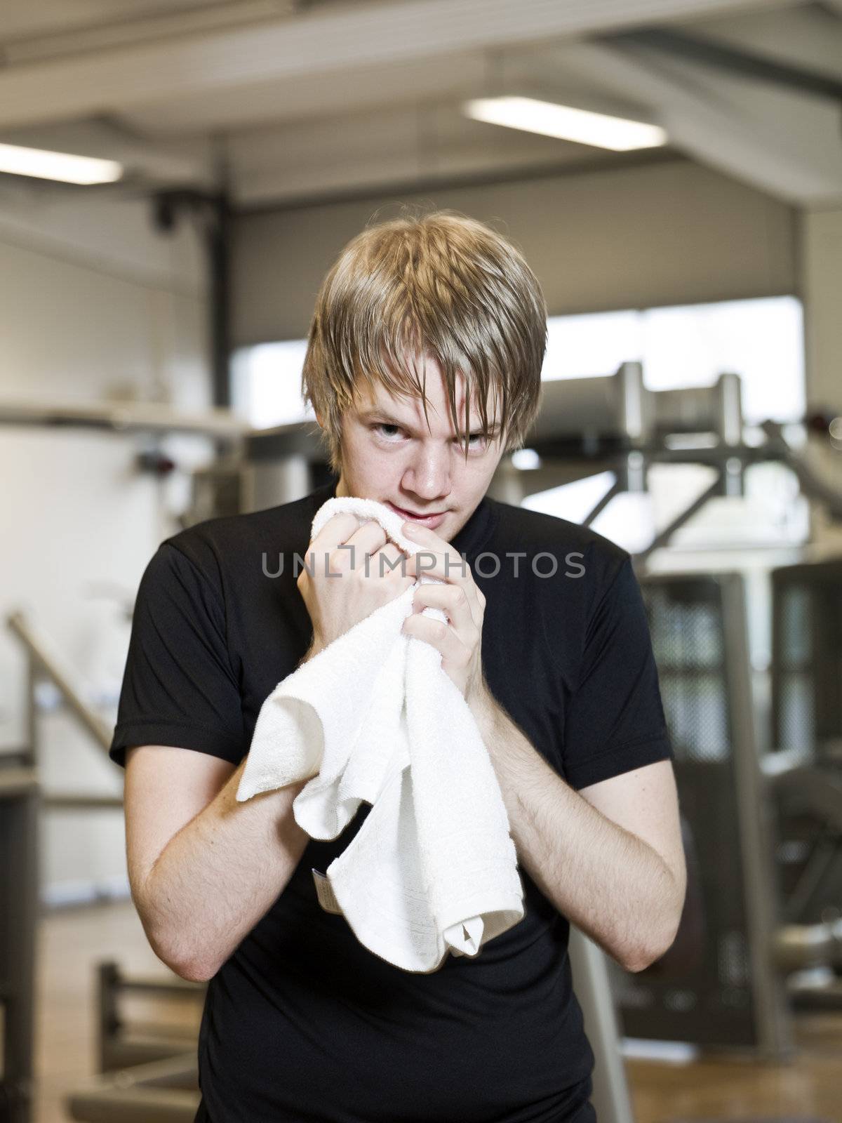 Young man taking a break from training at a fitness center