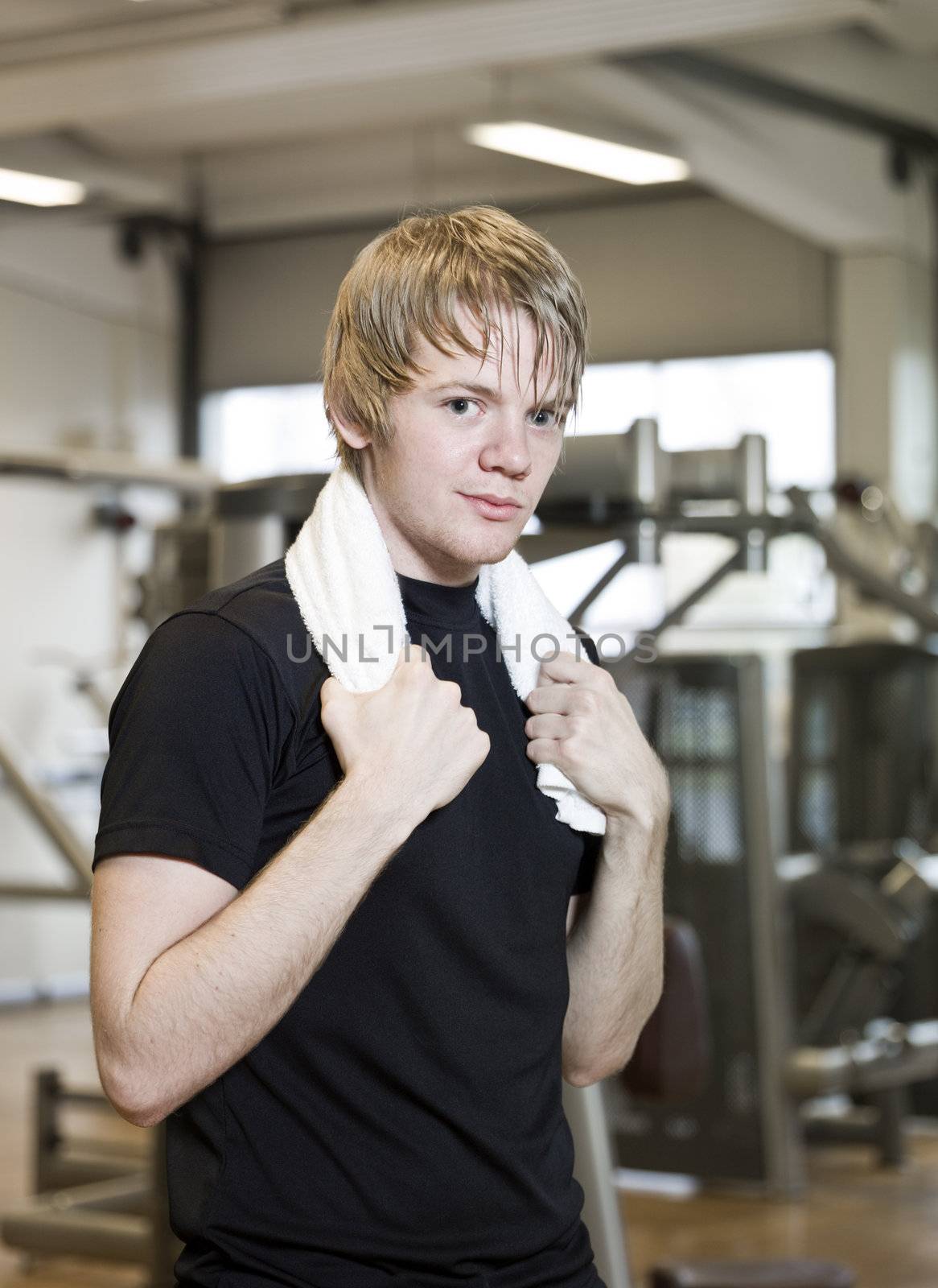 Young man taking a break from training at a fitness center