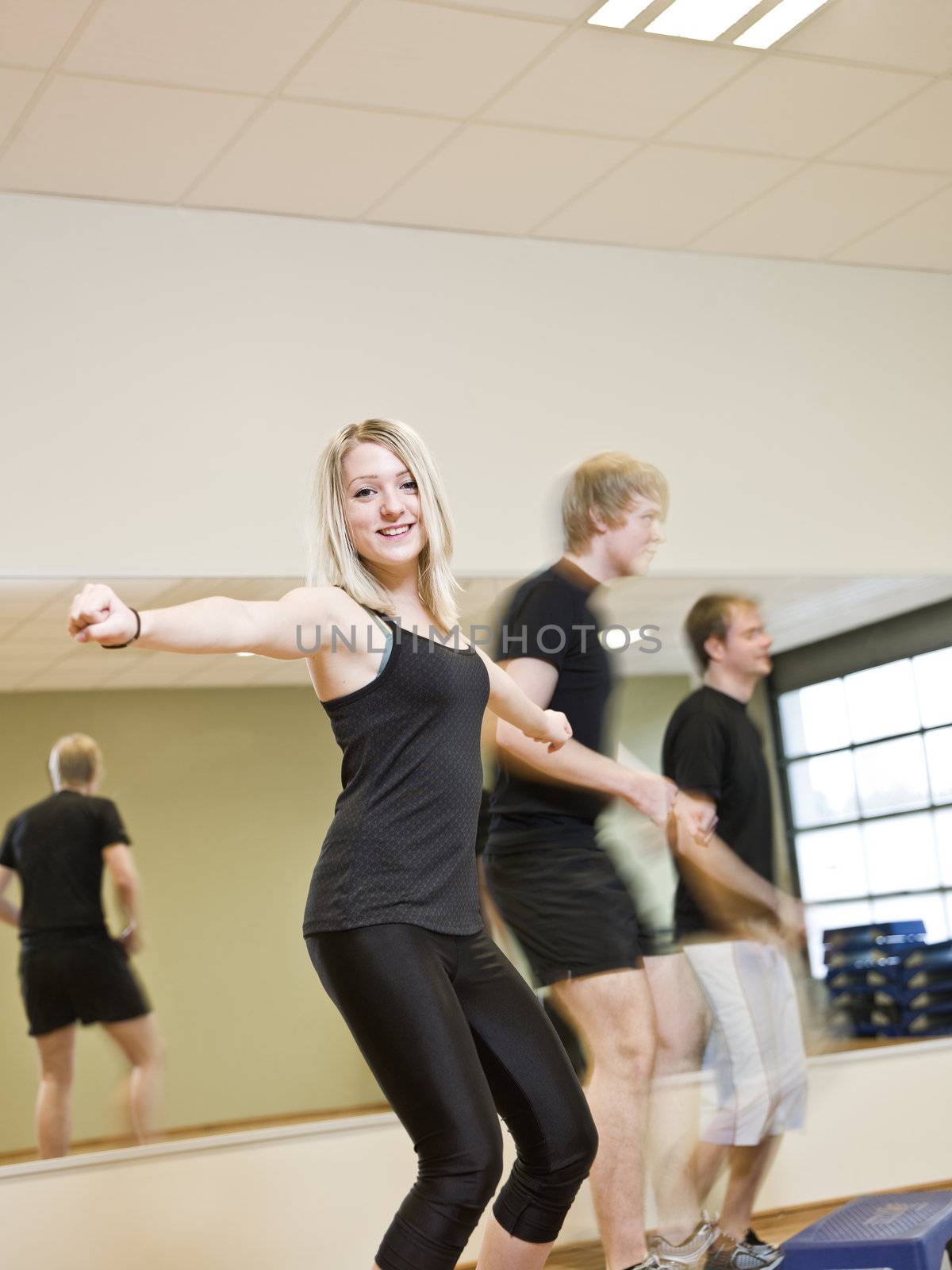 Group of people doing step up with a girl in focus