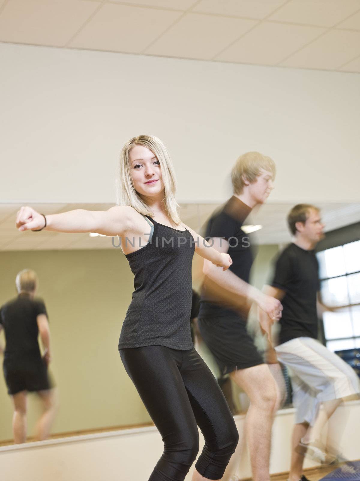 Group of people doing step up with a girl in focus