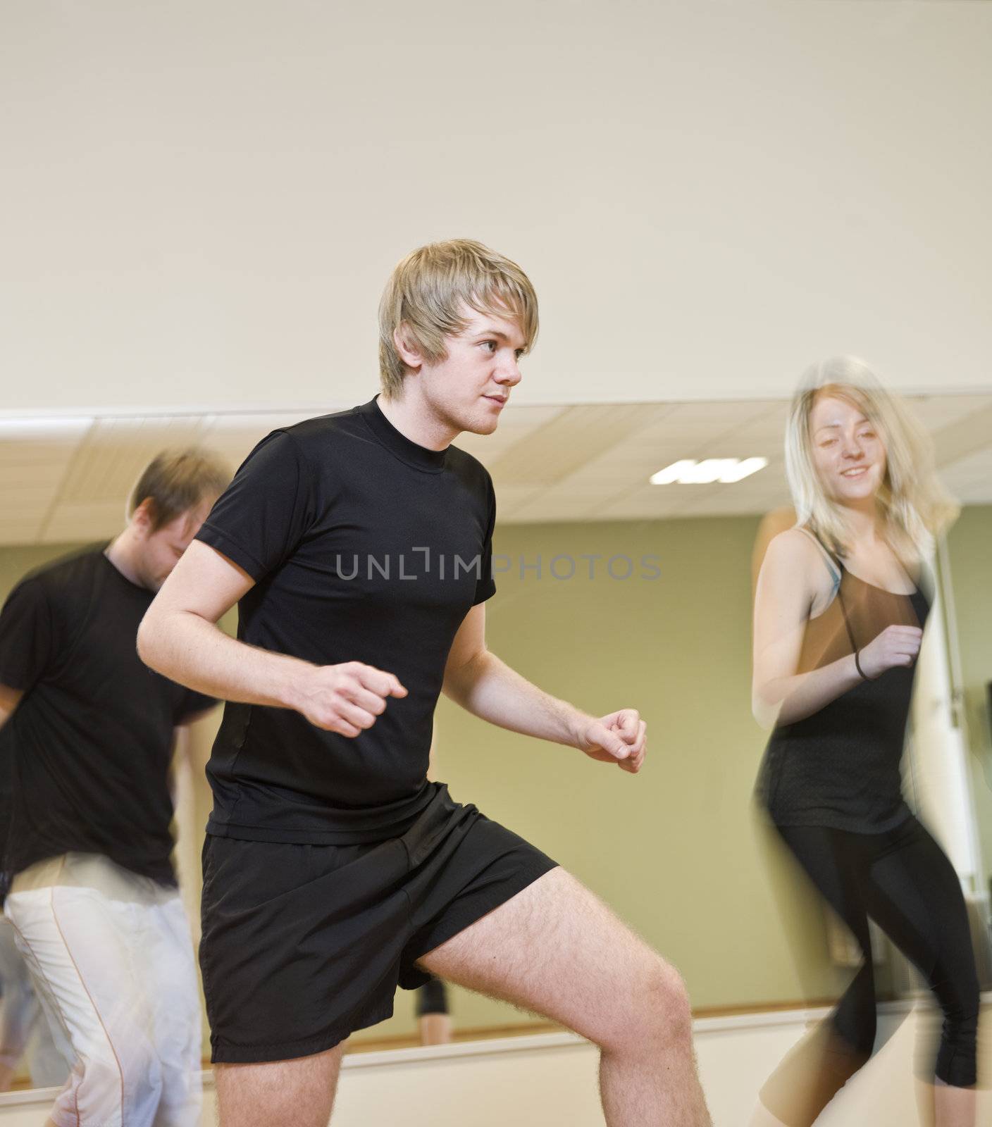 Group of people doing step up with a boy in focus
