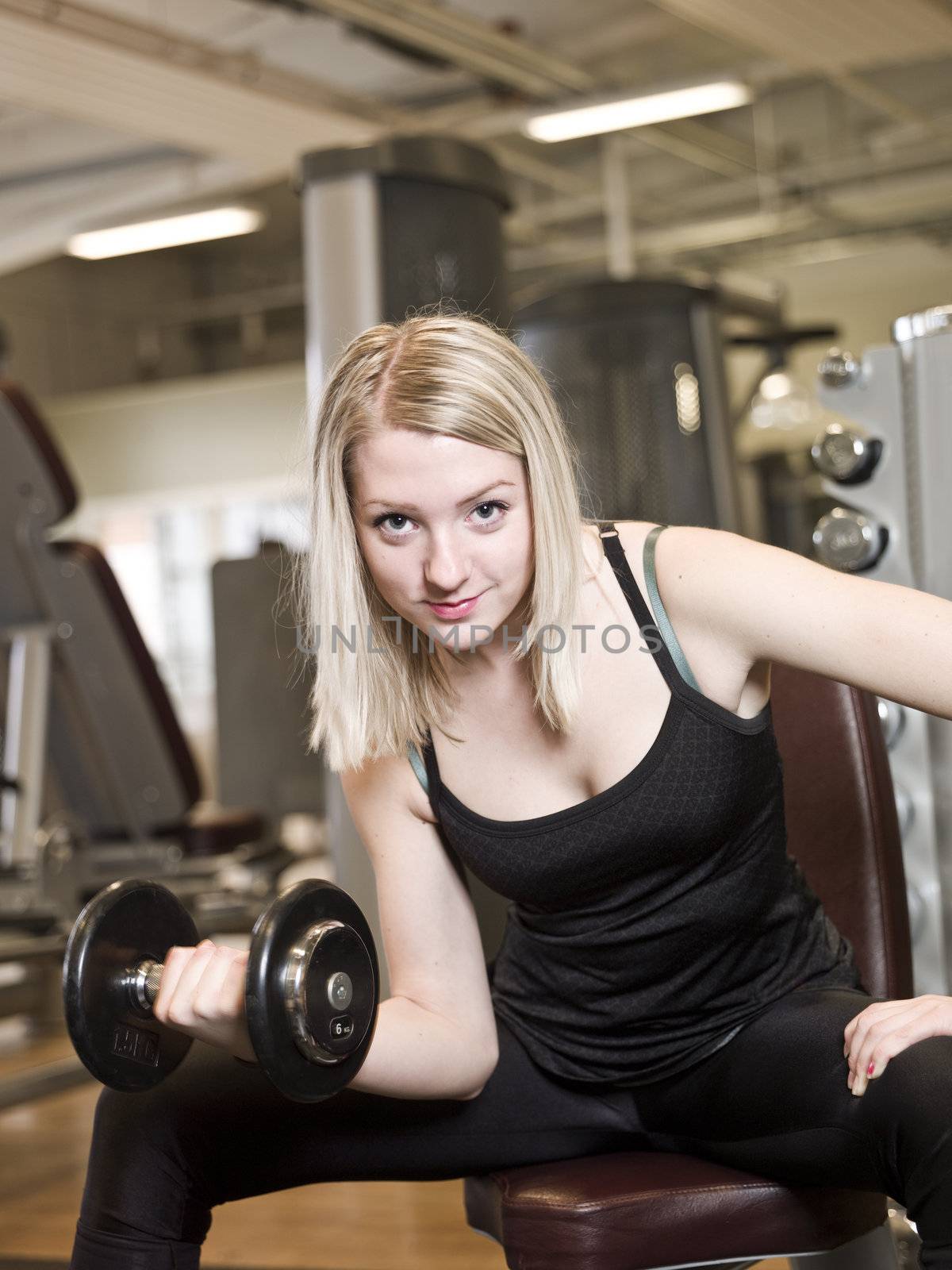 Young woman lifting weights at a fitness center