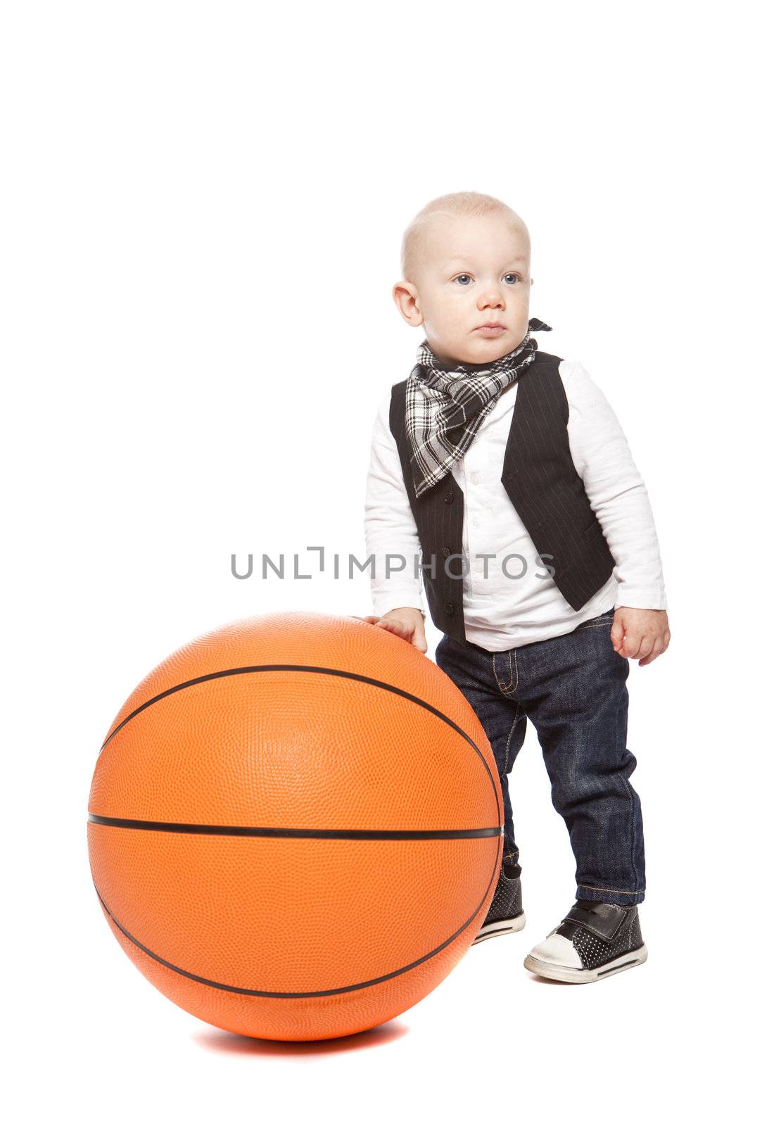 Fashion boy playing whit a huge basketball against a white background