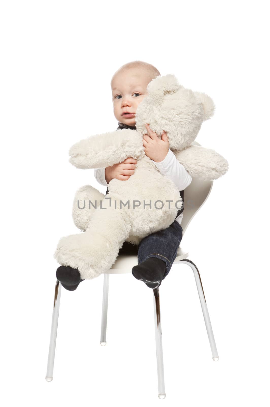 Young baby boy huging a toy isolated on a white background