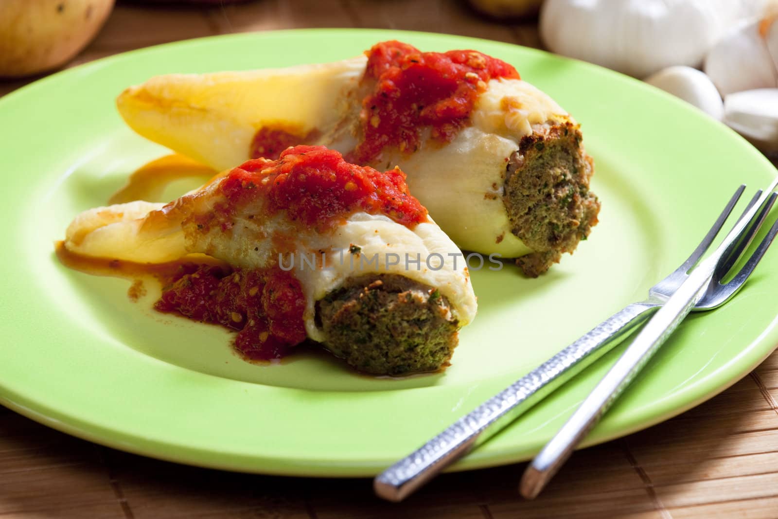 peppers filled with smoked meat and celery tops with tomato sauce