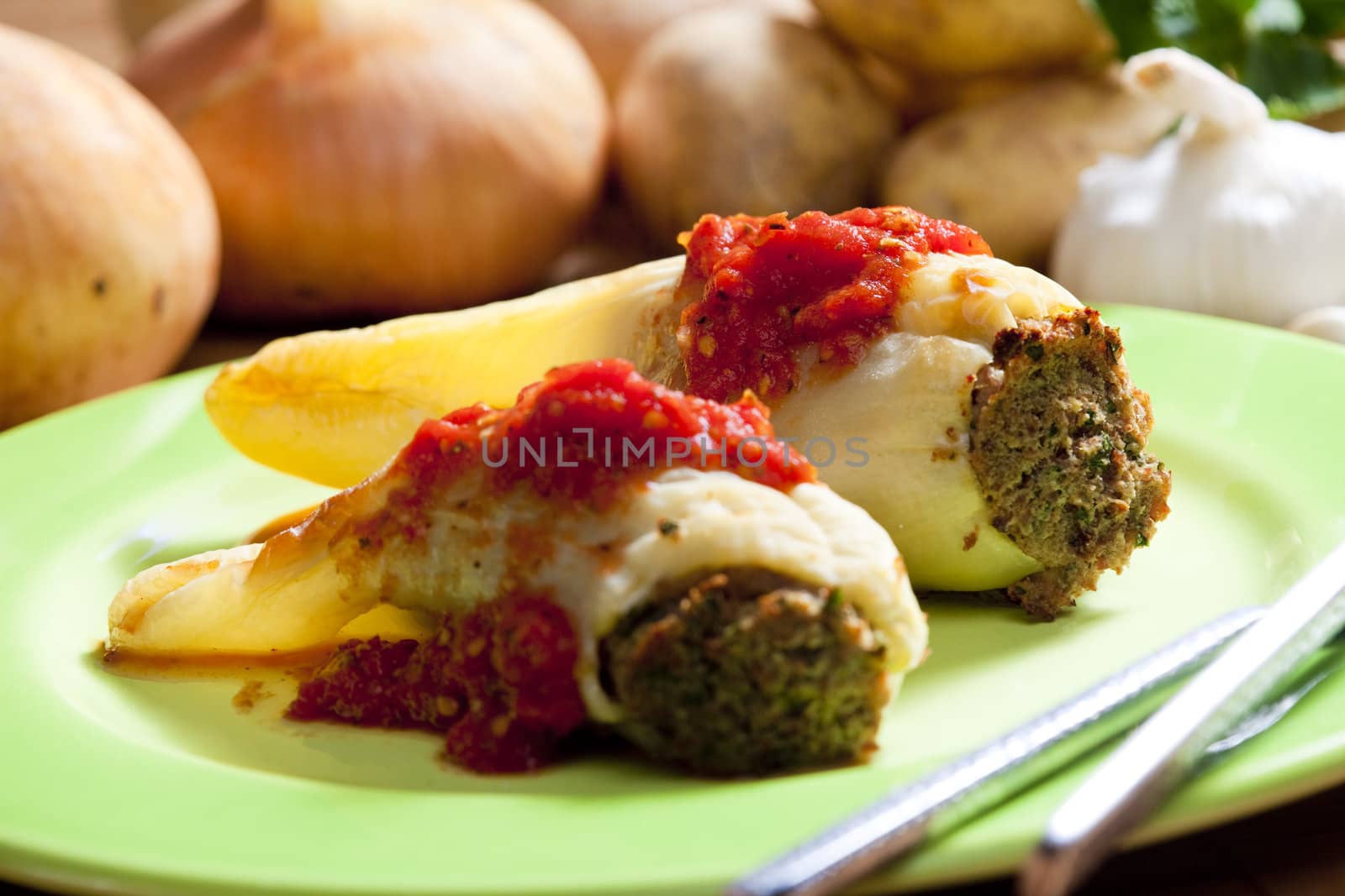 peppers filled with smoked meat and celery tops with tomato sauce