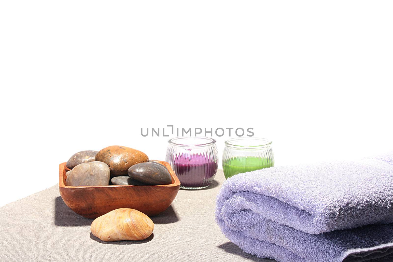Terry towel, sea stones in a basket and two aromatic candles for SPA.