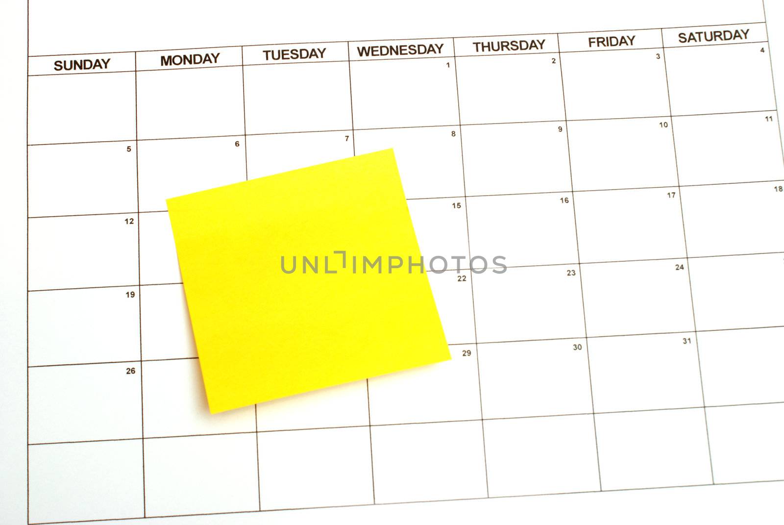 A blank sticky note for your text on a calendar as a reminder.