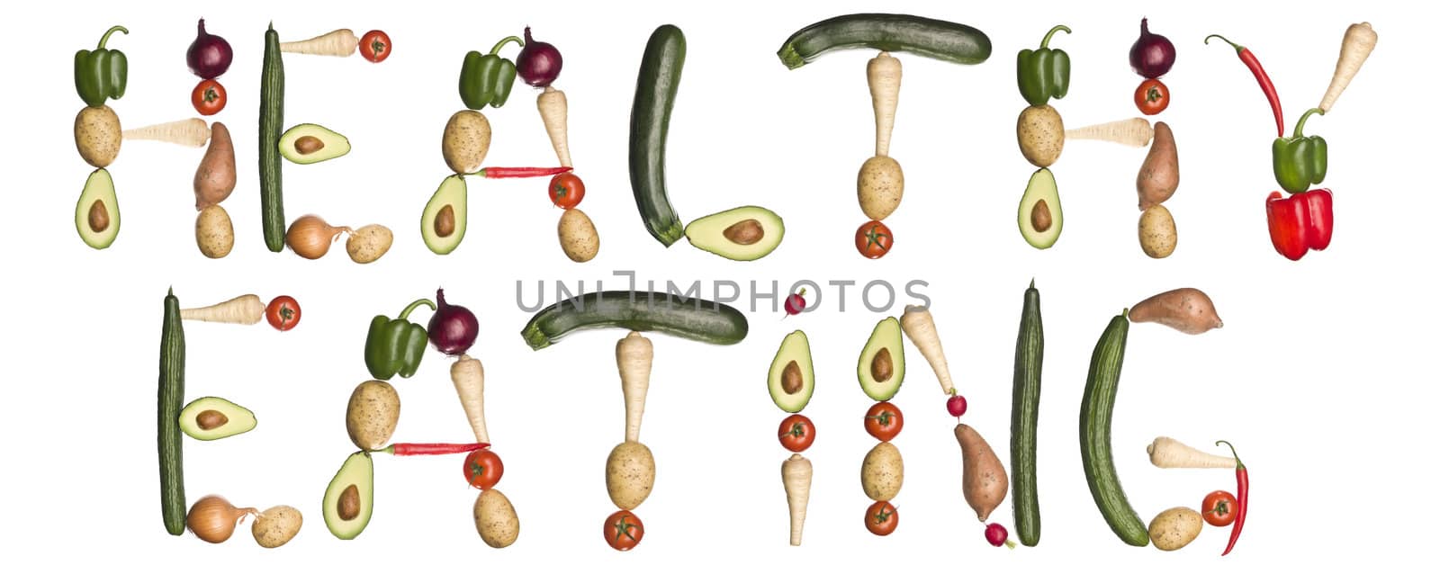 The phrase ''Healthy eating' made out of vegetables isolated on a white background