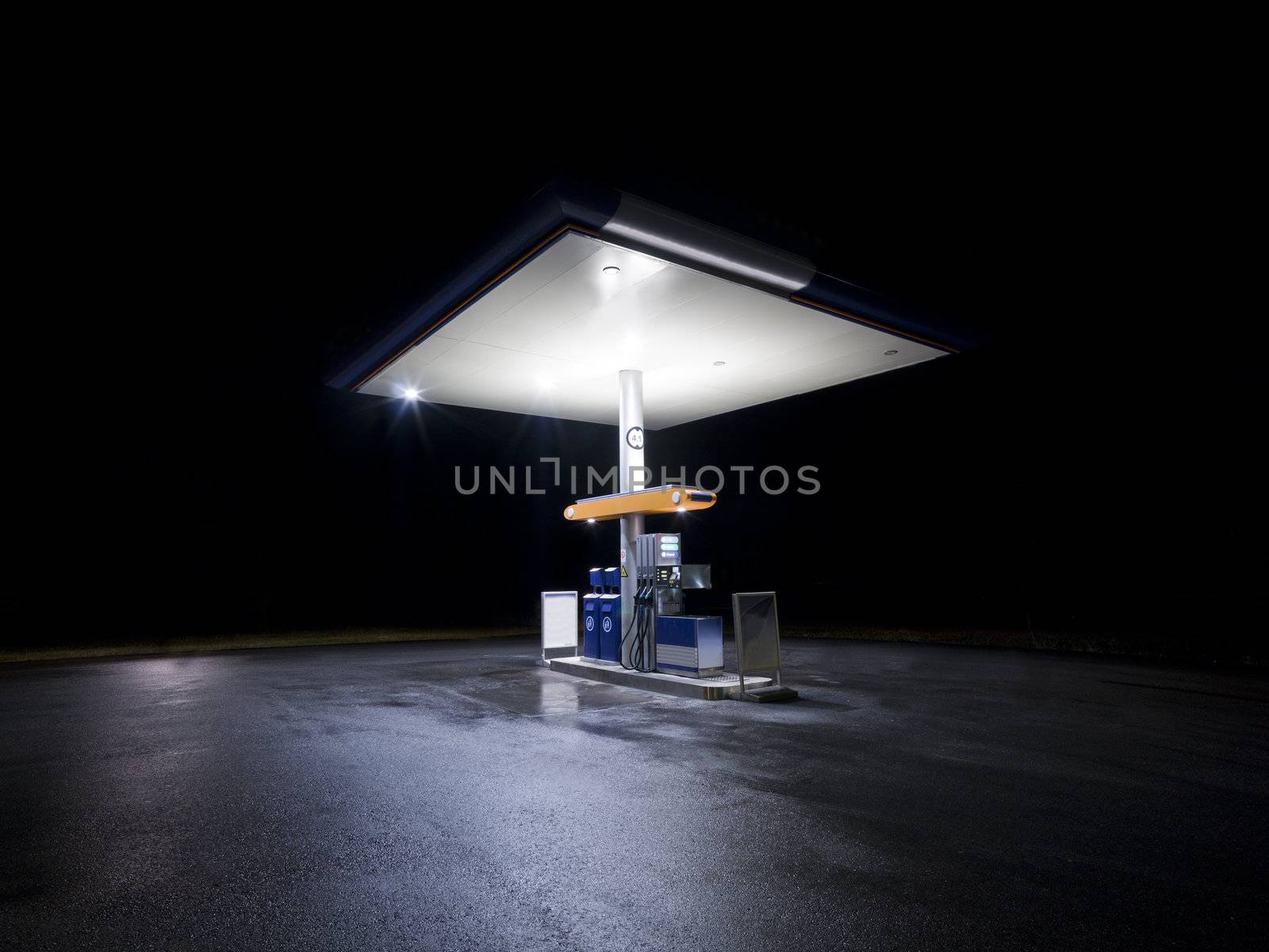 Petrol station at night with traffic in movement