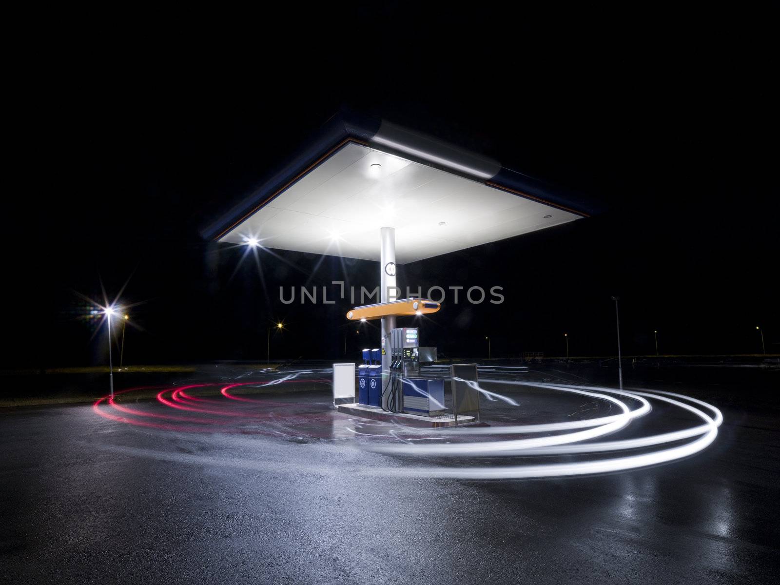 Petrol station at night with traffic in movement