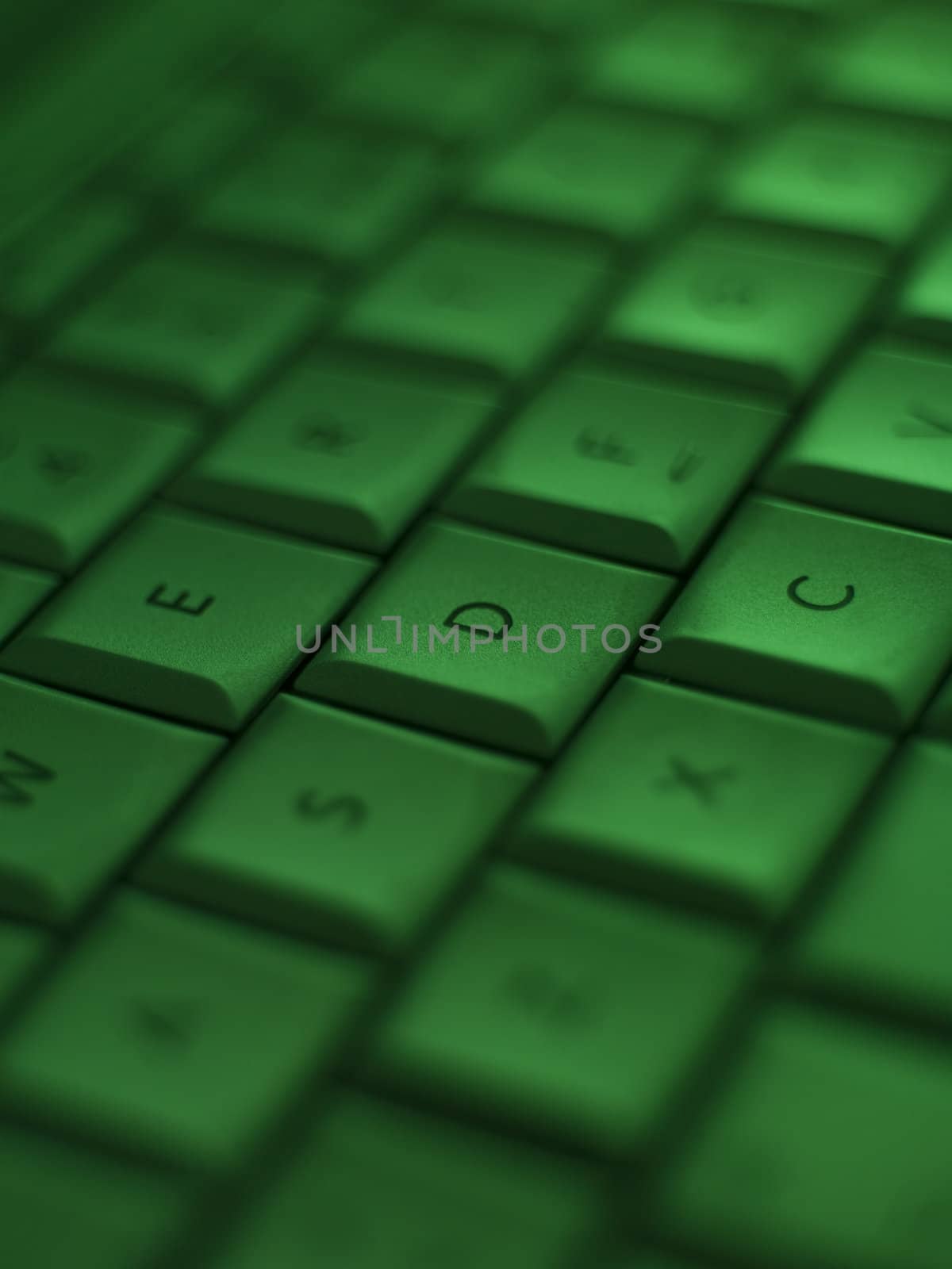 Closeup on a keyboard with a green tone