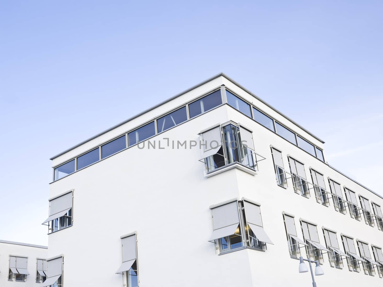 Modern white building during day time against a blue sky