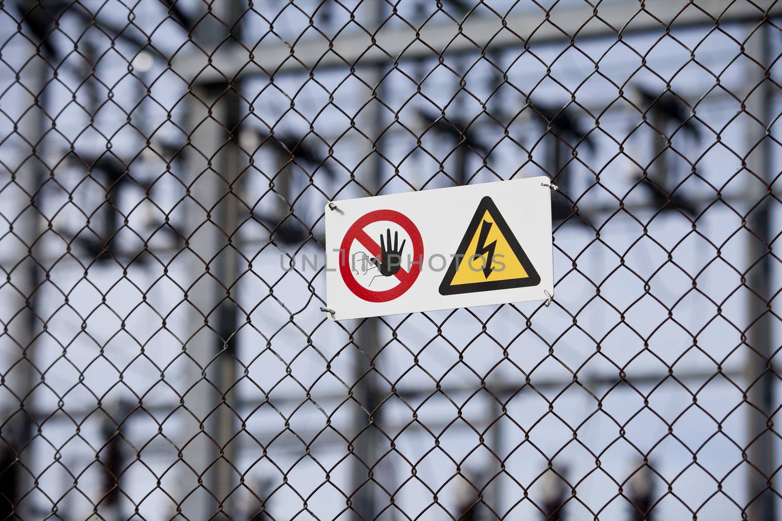 Warning signs on a fence with short focal depth.