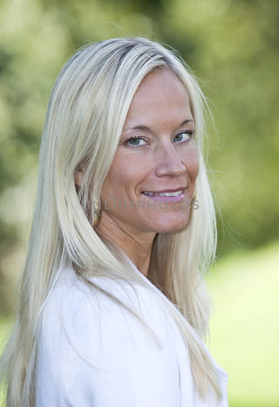 Portrait of a blonde woman smiling.