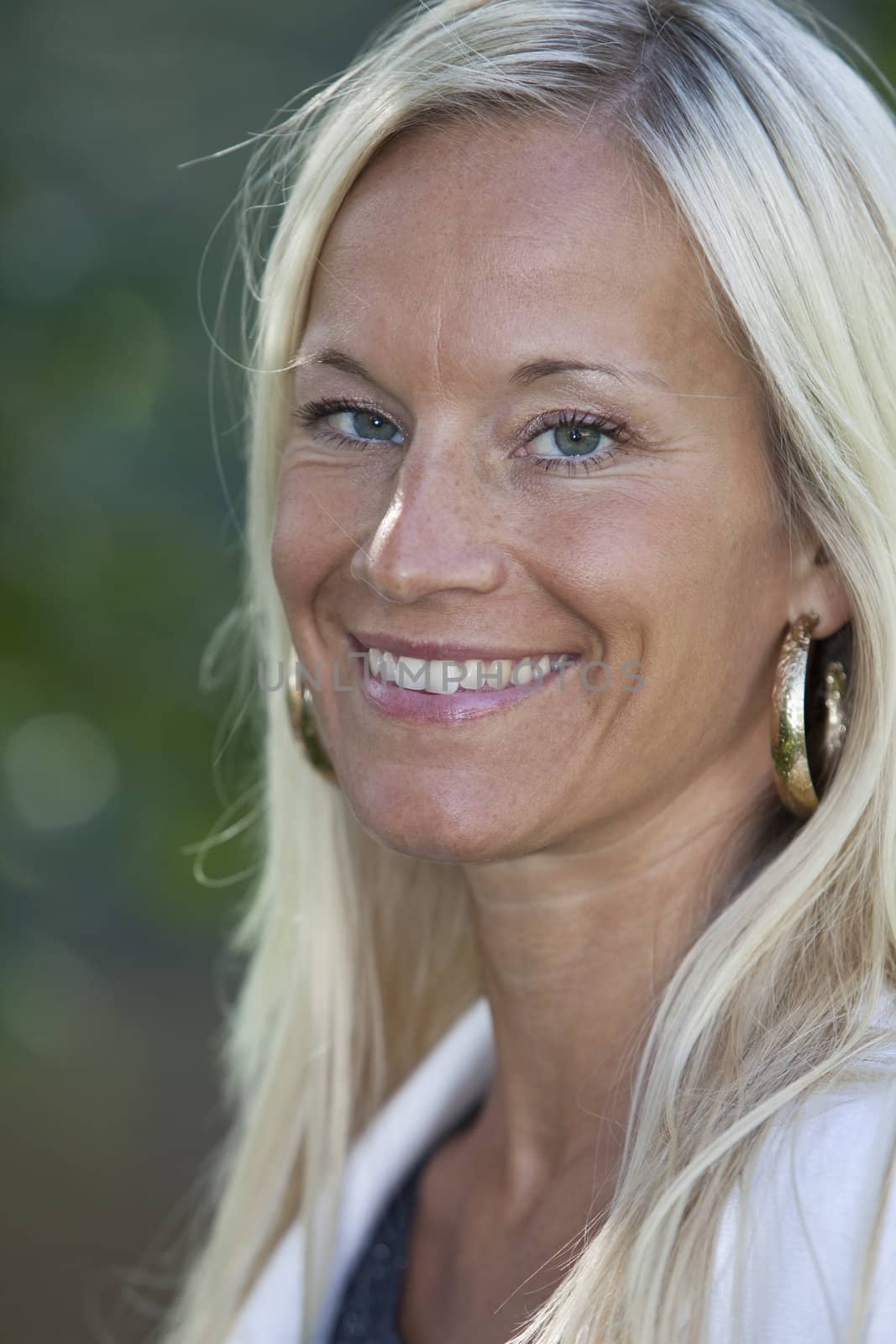 Portrait of a blonde woman smiling.