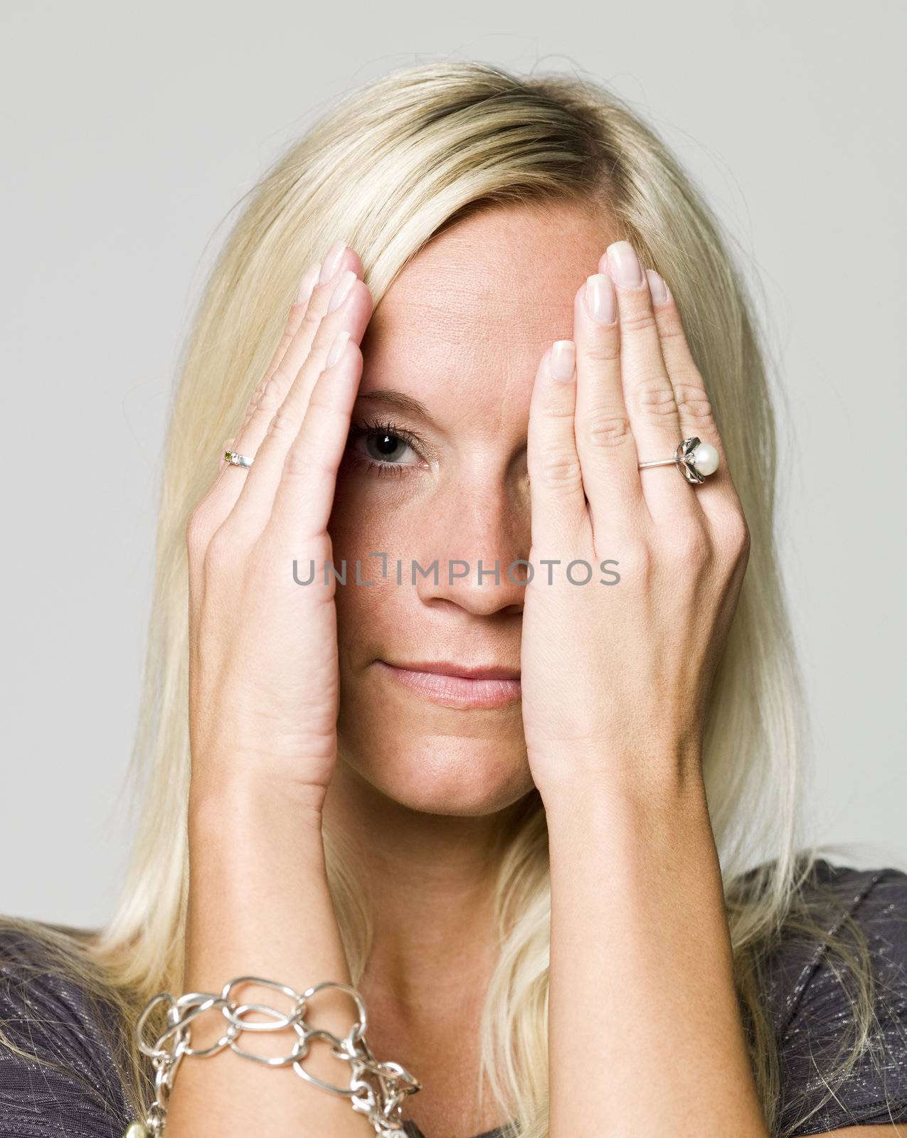 Portrait of a woman hiding in her hands