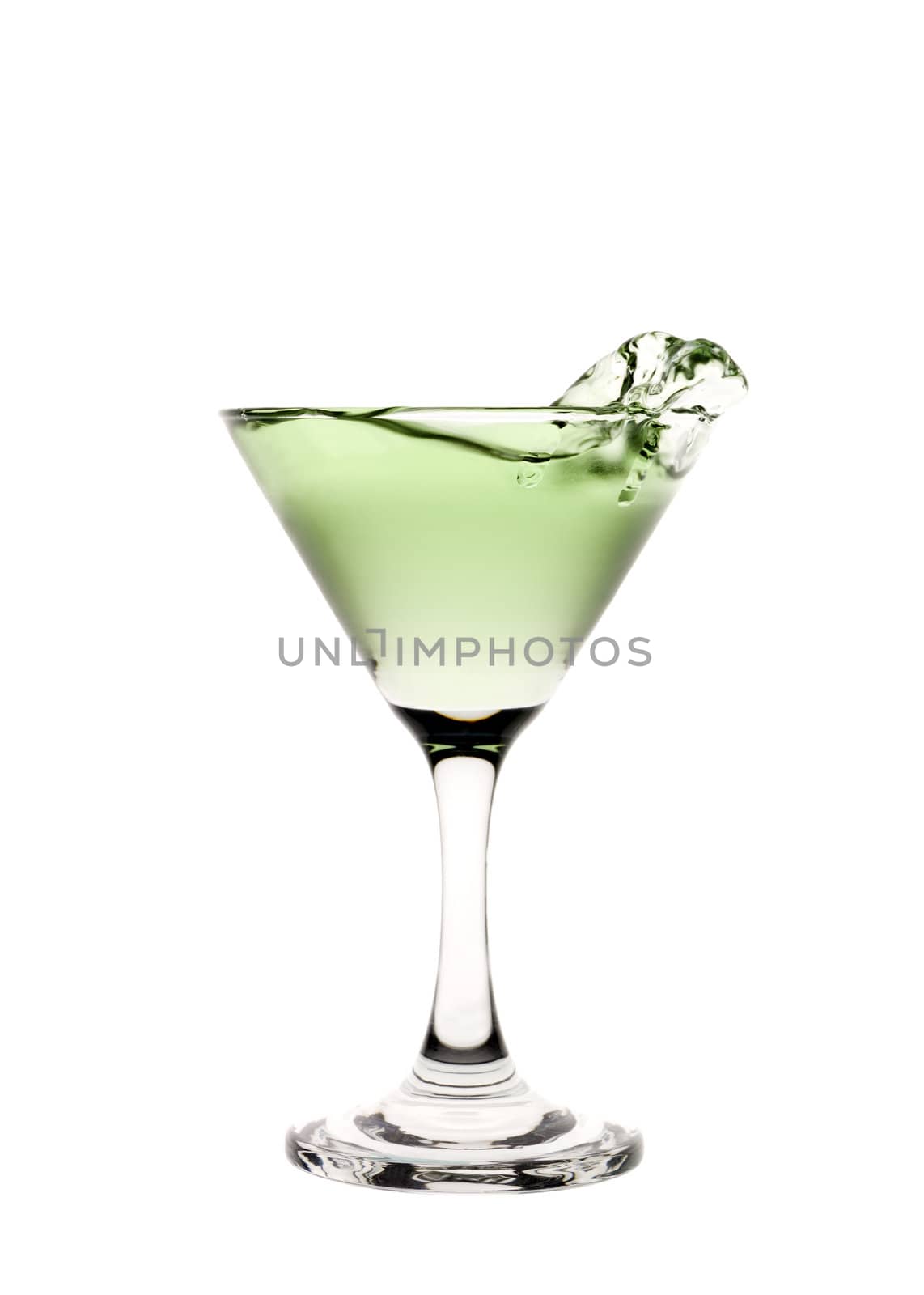 Green liquid splashing in a martini glass.