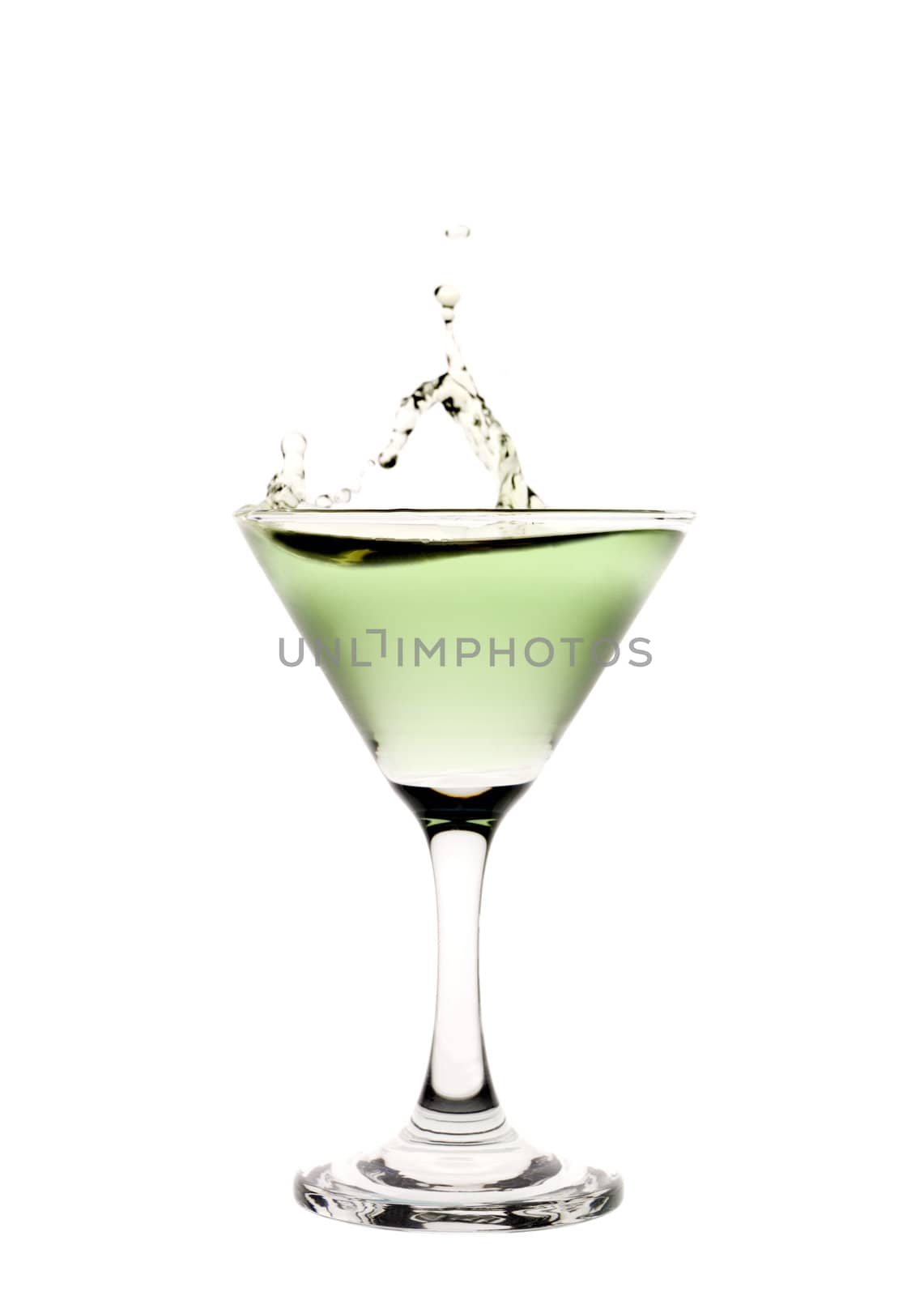 Green liquid splashing in a martini glass.