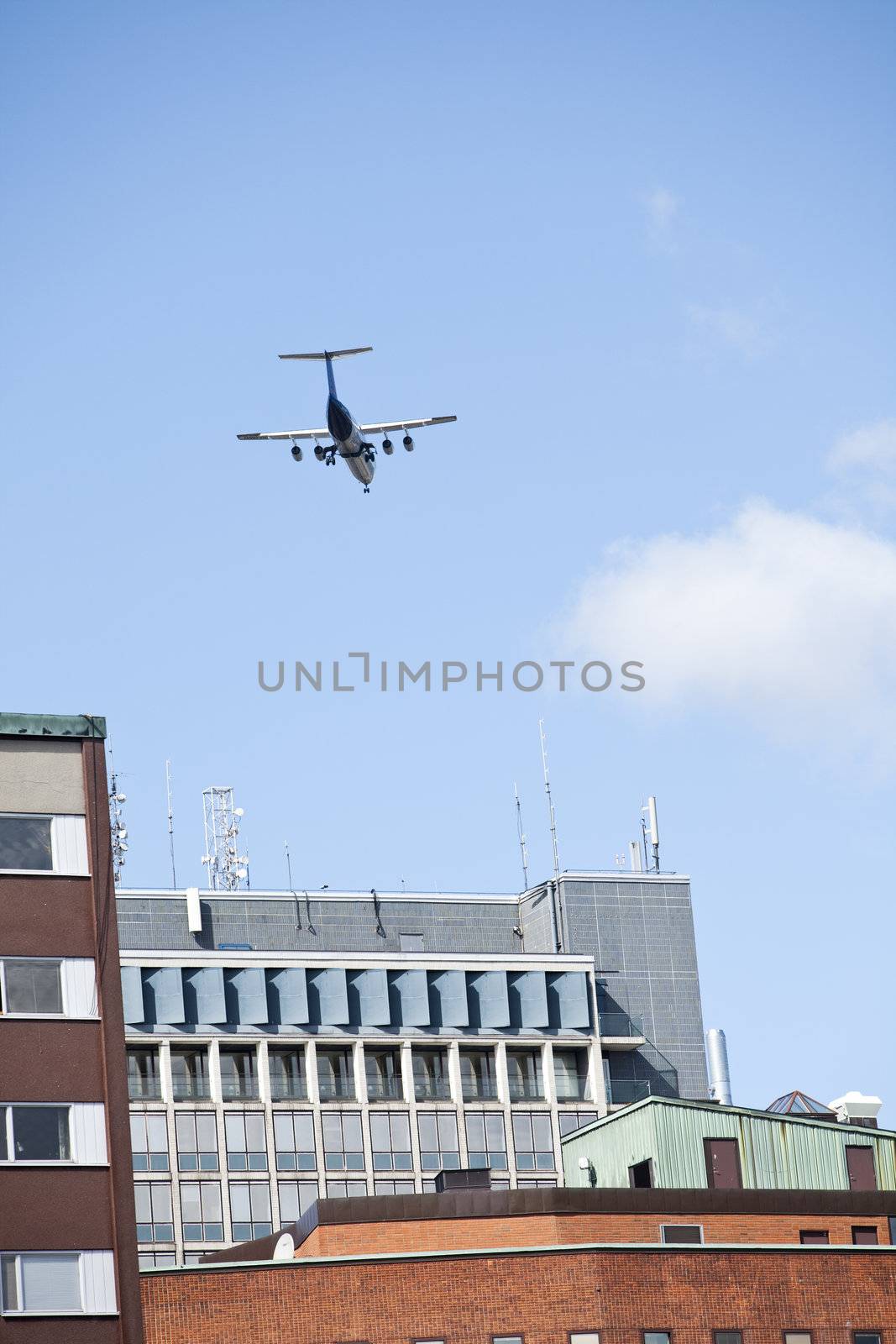 Aeroplane flying close to buildings